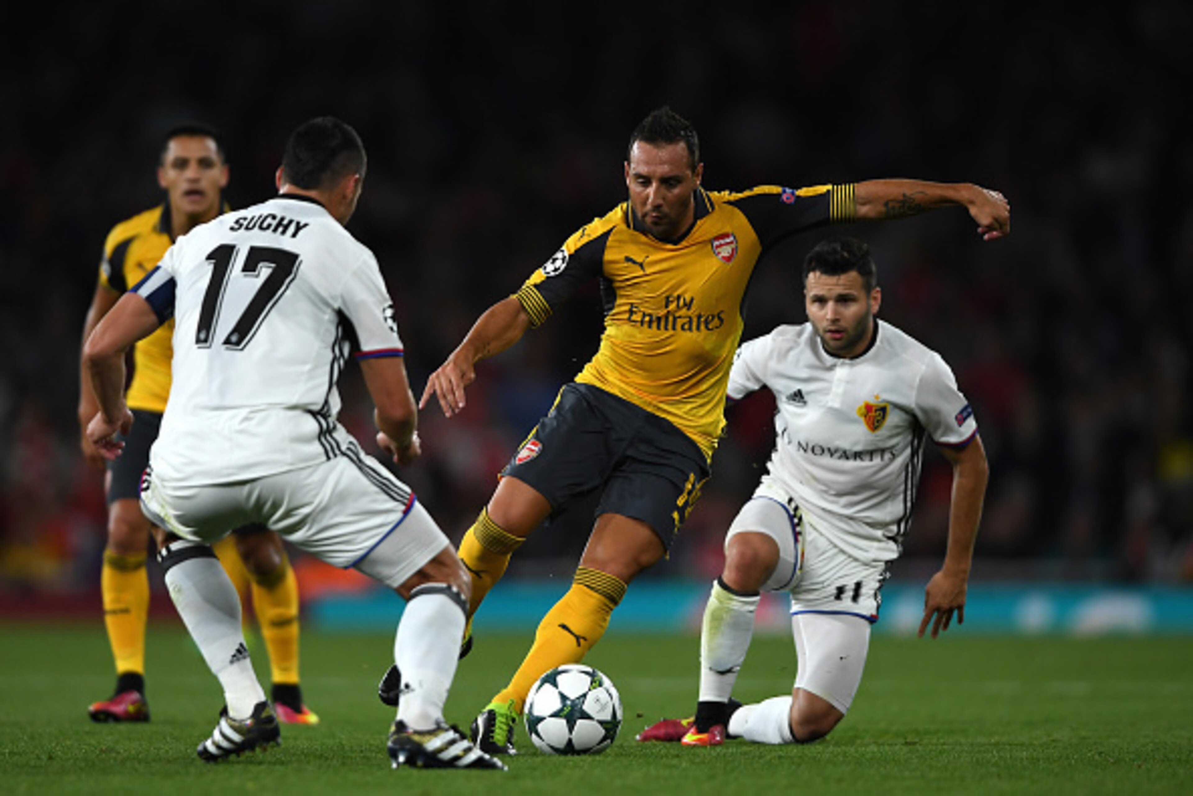 LONDON, ENGLAND - SEPTEMBER 28:  Santi Cazorla of Arsenal battles for the ball with Marek Suchy and Renato Steffen of Basel during the UEFA Champions League group A match between Arsenal FC and FC Basel 1893 at the Emirates Stadium on September 28, 2016 i