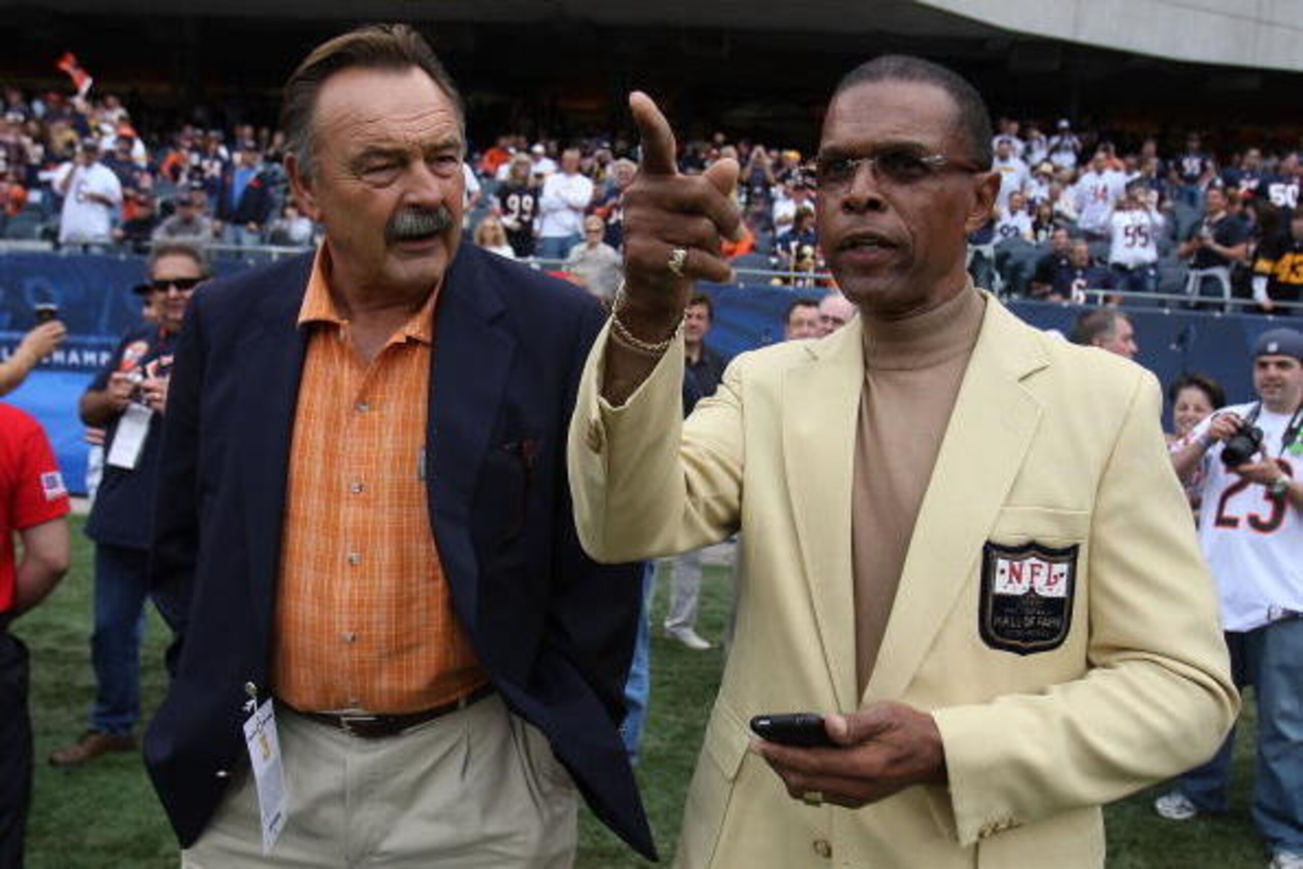 CHICAGO - SEPTEMBER 20: Hall of Fame Chicago Bears Dick Butkus (L) and Gale Sayers chat on the sidelines before a game between the Bears and the Pittsburgh Steelers on September 20, 2009 at Soldier Field in Chicago, Illinois. The Bears defeated the Steele
