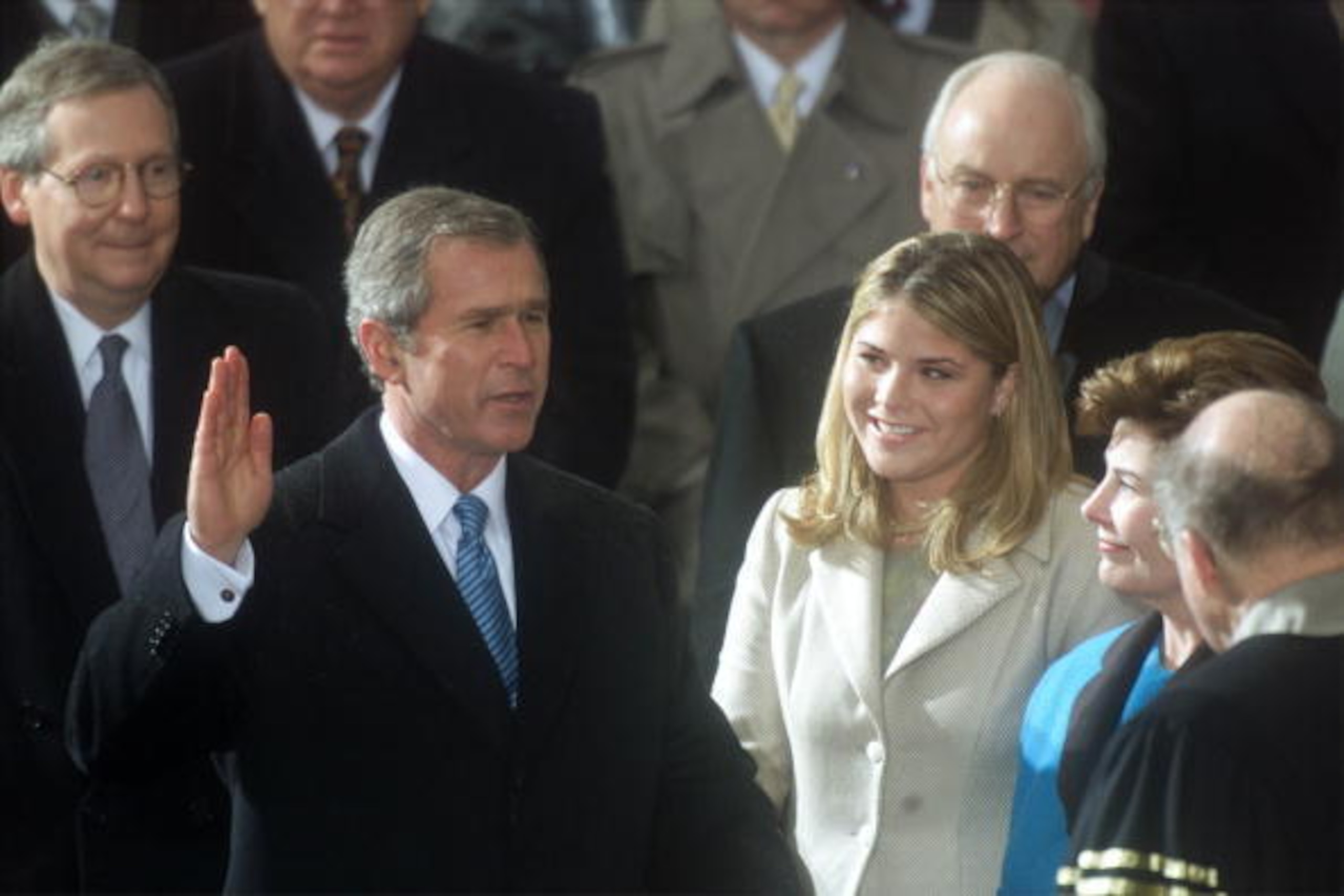 384539 02: George W. Bush, with his wife Laura holding the Bible, and with his daughter Jenna by his side, is sworn in as 43rd President of the United States by Supreme Court Chief Justice William Rehnquist January 20, 2001 outside the U.S. Capitol buildi