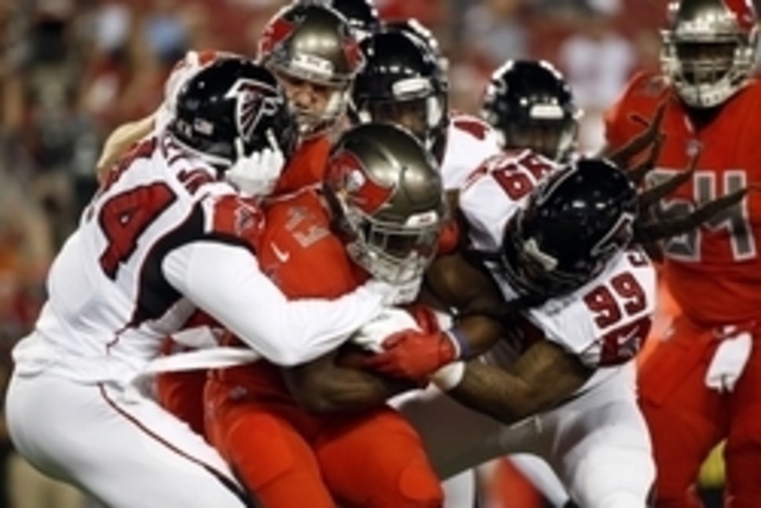 Nov 3, 2016; Tampa, FL, USA; Tampa Bay Buccaneers running back Peyton Barber (43) carries the ball as Atlanta Falcons outside linebacker Vic Beasley (44) and Falcons defensive end Adrian Clayborn (99) tackles during the first quarter at Raymond James Stad
