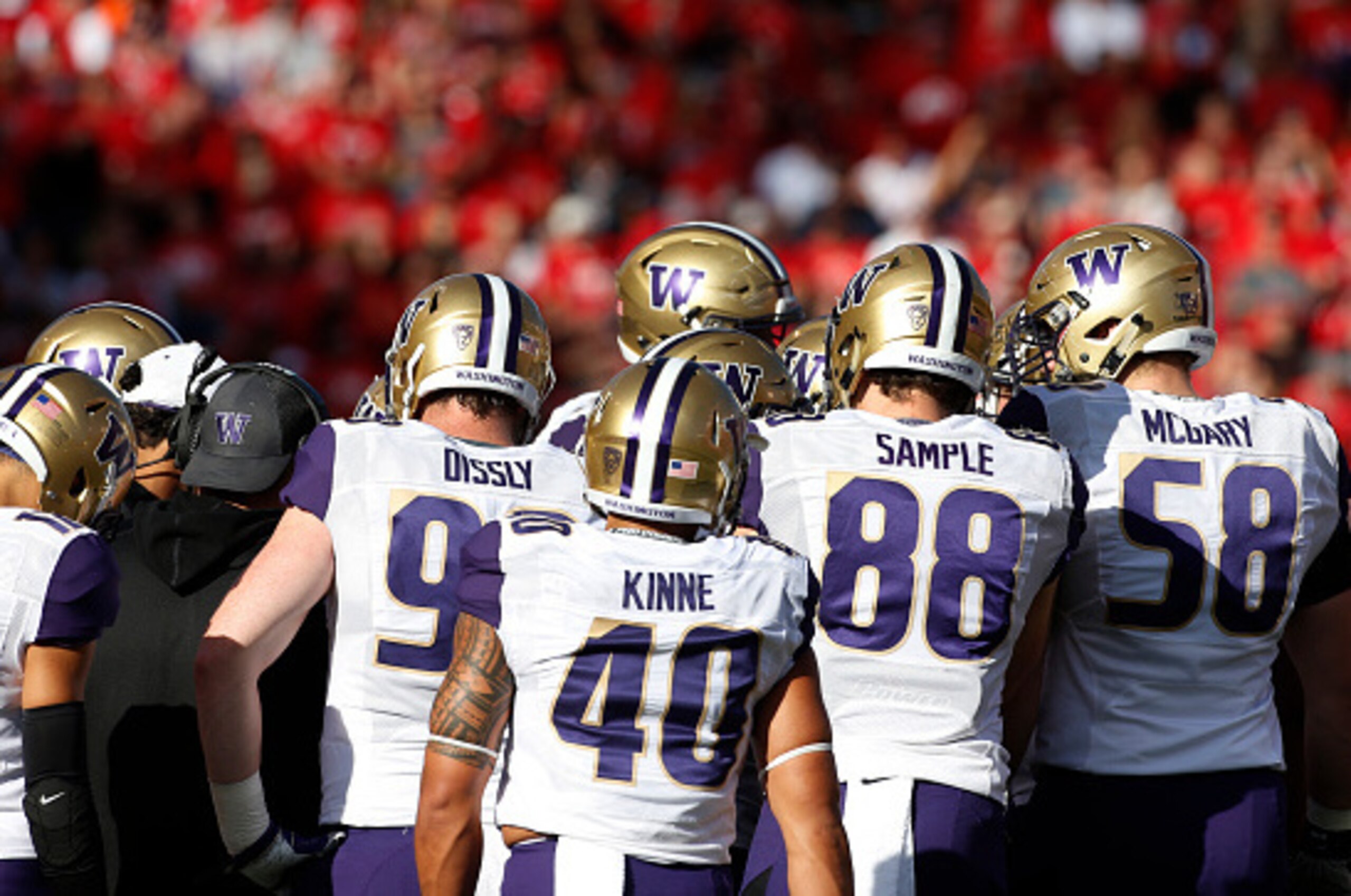 SALT LAKE CITY, UT - OCTOBER 29: Washington Huskies players huddle at the Utah Utes, Washington Huskies NCAA football game at Rice-Eccles Stadium on October 29, 2016 in Salt Lake City, Utah. (Photo by George Frey/Getty Images)