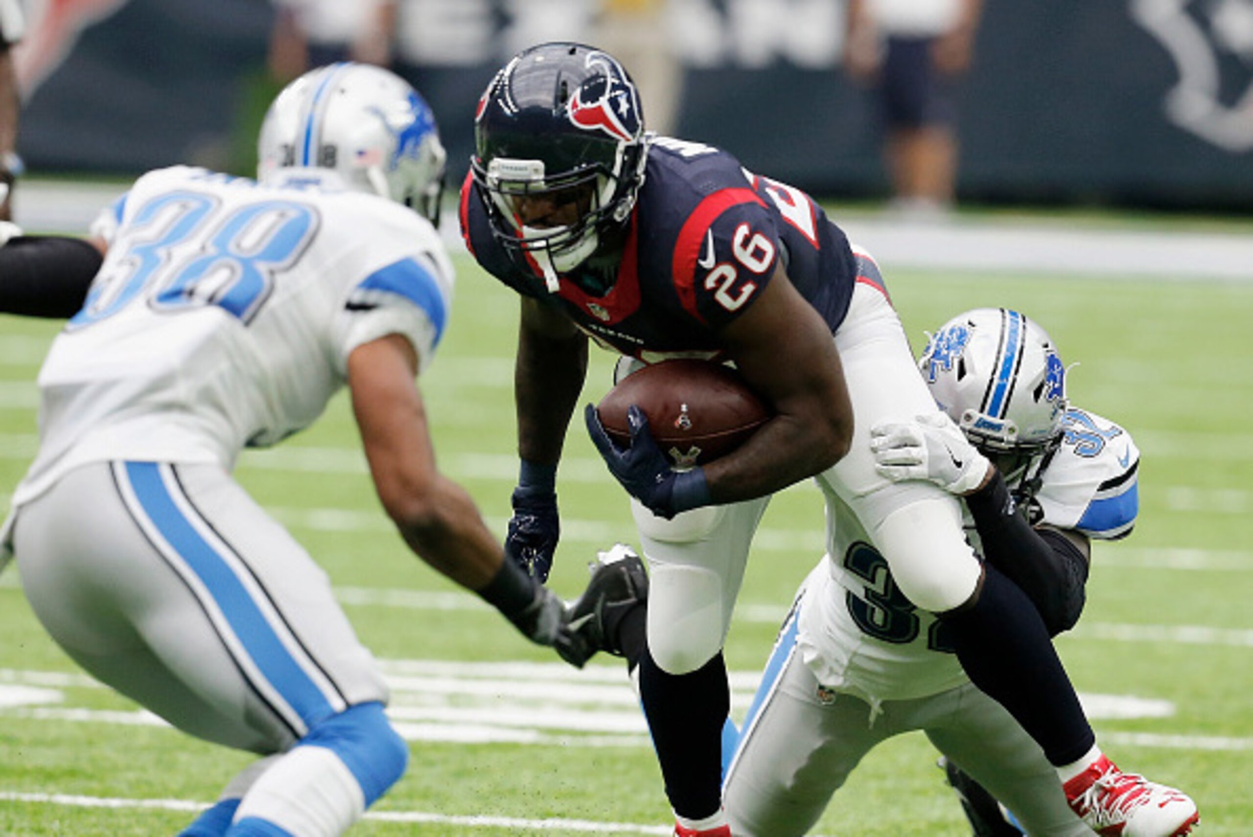 HOUSTON, TX - OCTOBER 30:  Lamar Miller #26 of the Houston Texans is tackled by Tavon Wilson #32 of the Detroit Lions in the second quarter during the game between between the Houston Texans and the Detroit Lions at NRG Stadium on October 30, 2016 in Hous