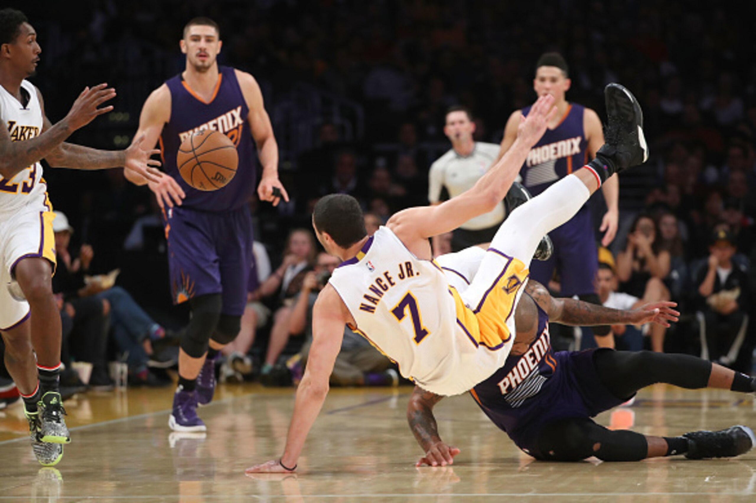 LOS ANGELES, CA - NOVEMBER 06:  Larry Nance Jr. #7 of the Los Angeles Lakers falls over after being fouled by P.J. Tucker #17 of the Phoenix Suns during the firt half of the NBA game at Staples Center on November 6, 2016 in Los Angeles, California. NOTE T
