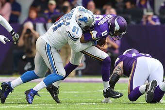 MINNEAPOLIS, MN - NOVEMBER 6: Sam Bradford #8 of the Minnesota Vikings is tackled by Kerry Hyder #61 of the Detroit Lions of the game on November 6, 2016 at US Bank Stadium in Minneapolis, Minnesota. (Photo by Adam Bettcher/Getty Images)