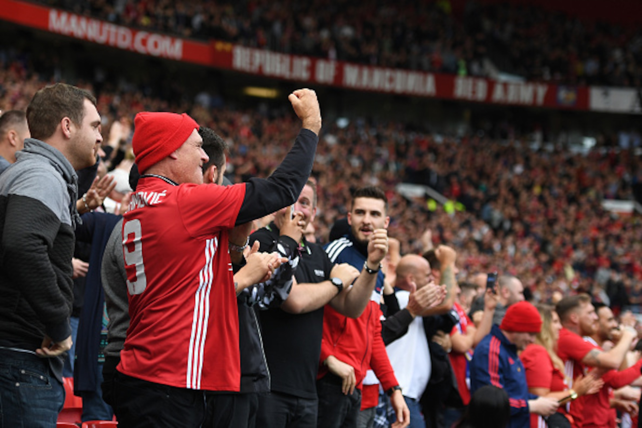 MANCHESTER, ENGLAND - SEPTEMBER 24: Manchester United fans react to their team scoring during the Premier League match between Manchester United and Leicester City at Old Trafford on September 24, 2016 in Manchester, England.  (Photo by Laurence Griffiths
