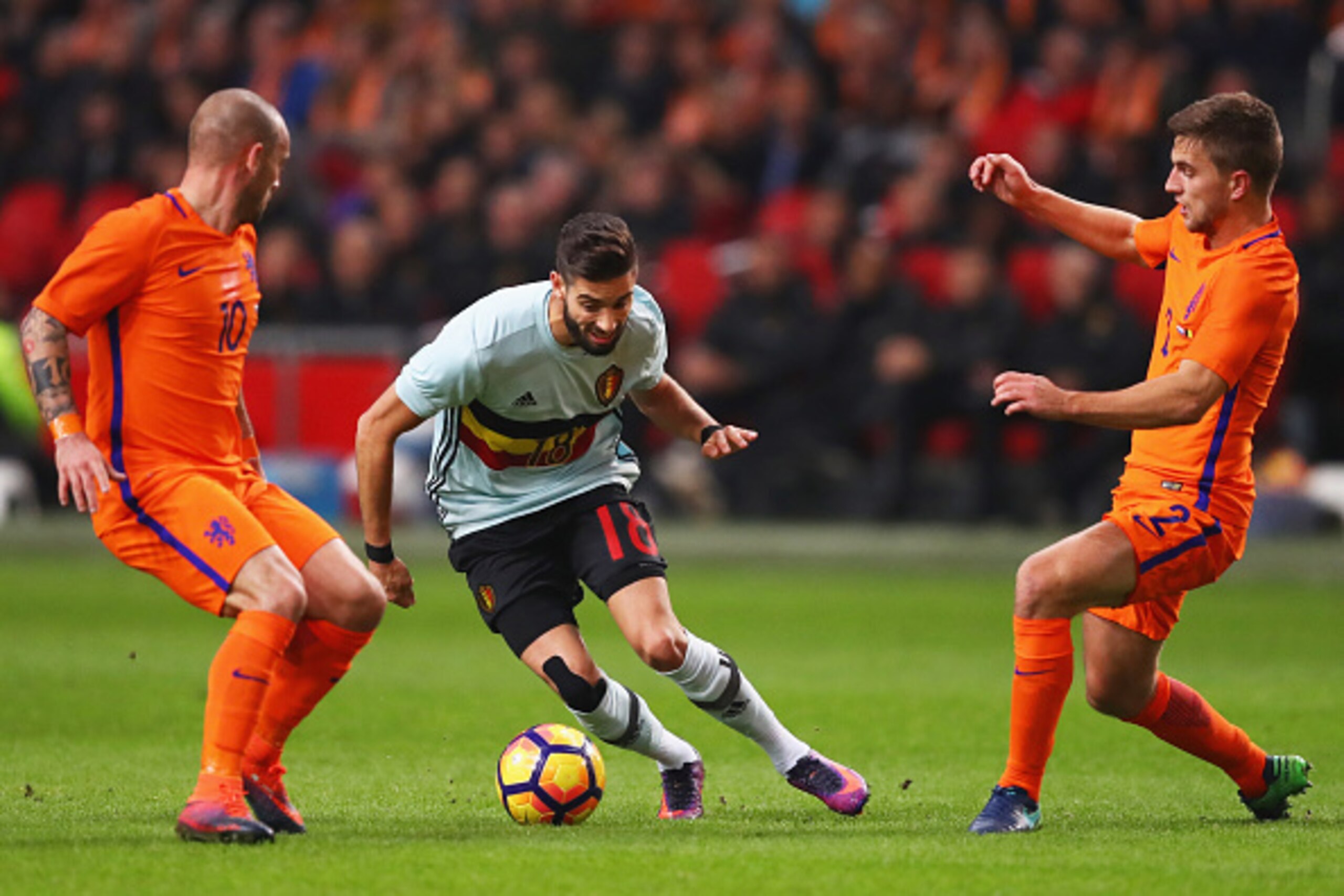 AMSTERDAM, NETHERLANDS - NOVEMBER 09: Yannick Carrasco of Belgium takes on Wesley Sneijder (L) and Joel Veltman of the Netherlands during the international friendly match between Netherlands and Belgium at Amsterdam Arena on November 9, 2016 in Amsterdam AMSTERDAM, NETHERLANDS - NOVEMBER 09: Yannick Carrasco of Belgium takes on Wesley Sneijder (L) and Joel Veltman of the Netherlands during the international friendly match between Netherlands and Belgium at Amsterdam Arena on November 9, 2016 in Amsterdam