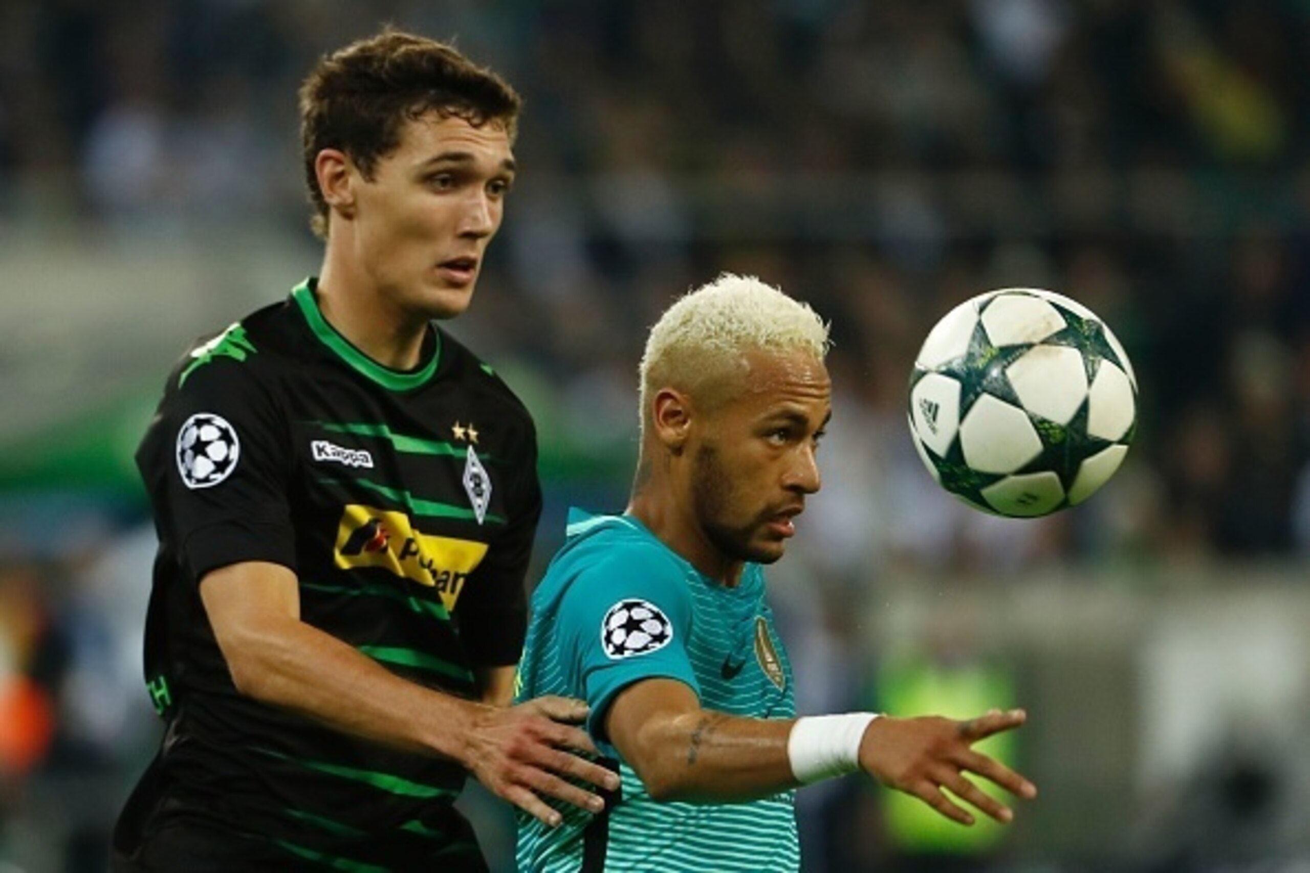 Barcelona's Brazilian forward Neymar (R) and Moenchengladbach's Danish defender Andreas Christensen vie for the ball during the UEFA Champions League first-leg group C football match between Borussia Moenchengladbach and FC Barcelona at the Borussia Park 
