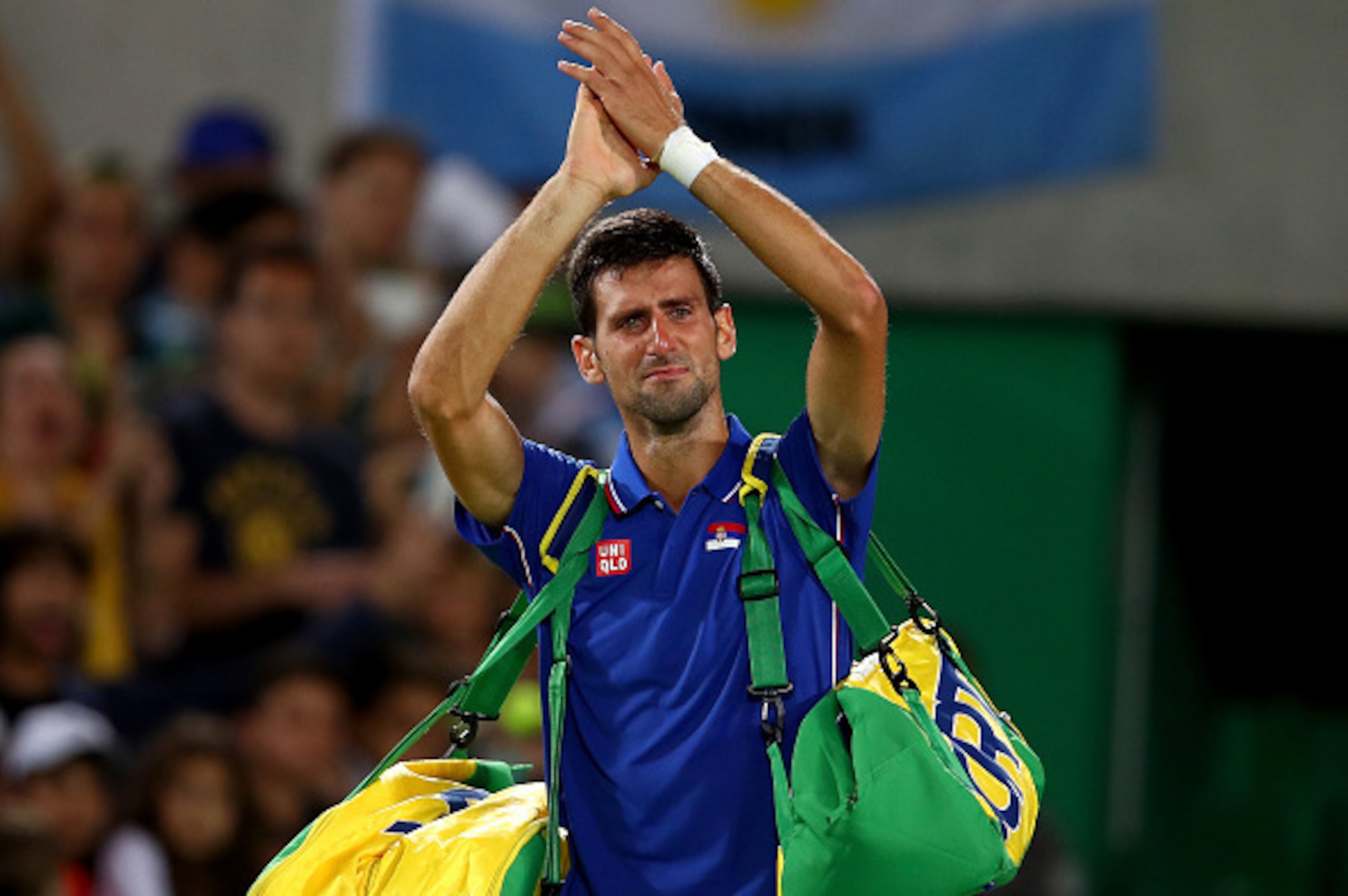 RIO DE JANEIRO, BRAZIL - AUGUST 07:  Novak Djokovic of Serbia shows his emotion as he waves to the crowd after his defeat against Juan Martin Del Potro of Argentina in their singles match on Day 2 of the Rio 2016 Olympic Games at the Olympic Tennis Centre