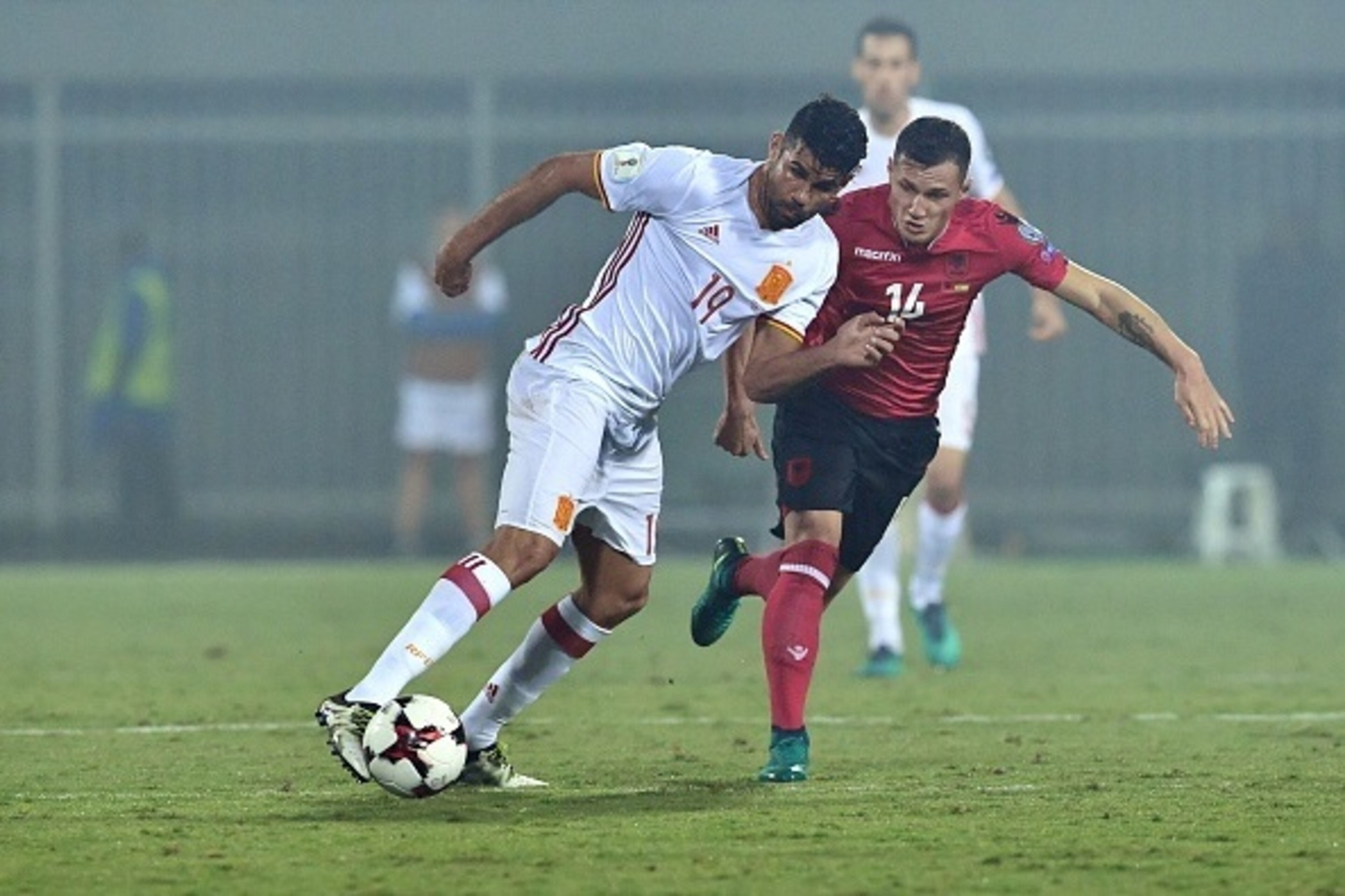 Spain's Diego Costa (L) vies with Albania's Taulant Xhaka during the FIFA World Cup 2018 qualification football match Albania vs Spain at the Loro-Borici stadium in Shkoder, on October 9, 2016. / AFP / Andrej ISAKOVIC        (Photo credit should read ANDR