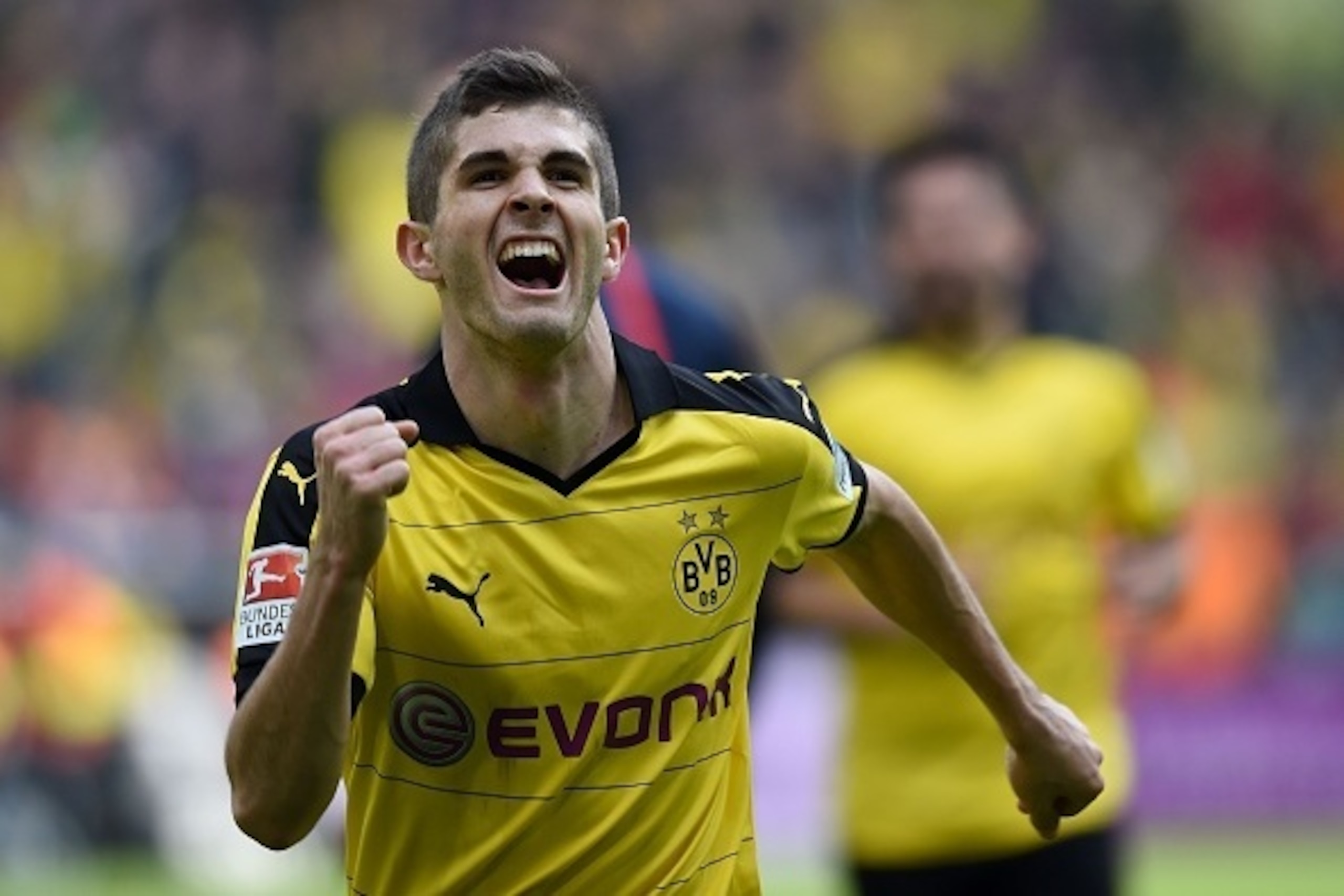 Dortmund's midfielder Christian Pulisic celebrates scoring the 1-0 goal during the German Bundesliga first division football match BVB Borussia Dortmund vs Hamburg SV in Dortmund, western Germany, on April 17, 2016. 

 / AFP / PATRIK STOLLARZ / RESTRICTIO