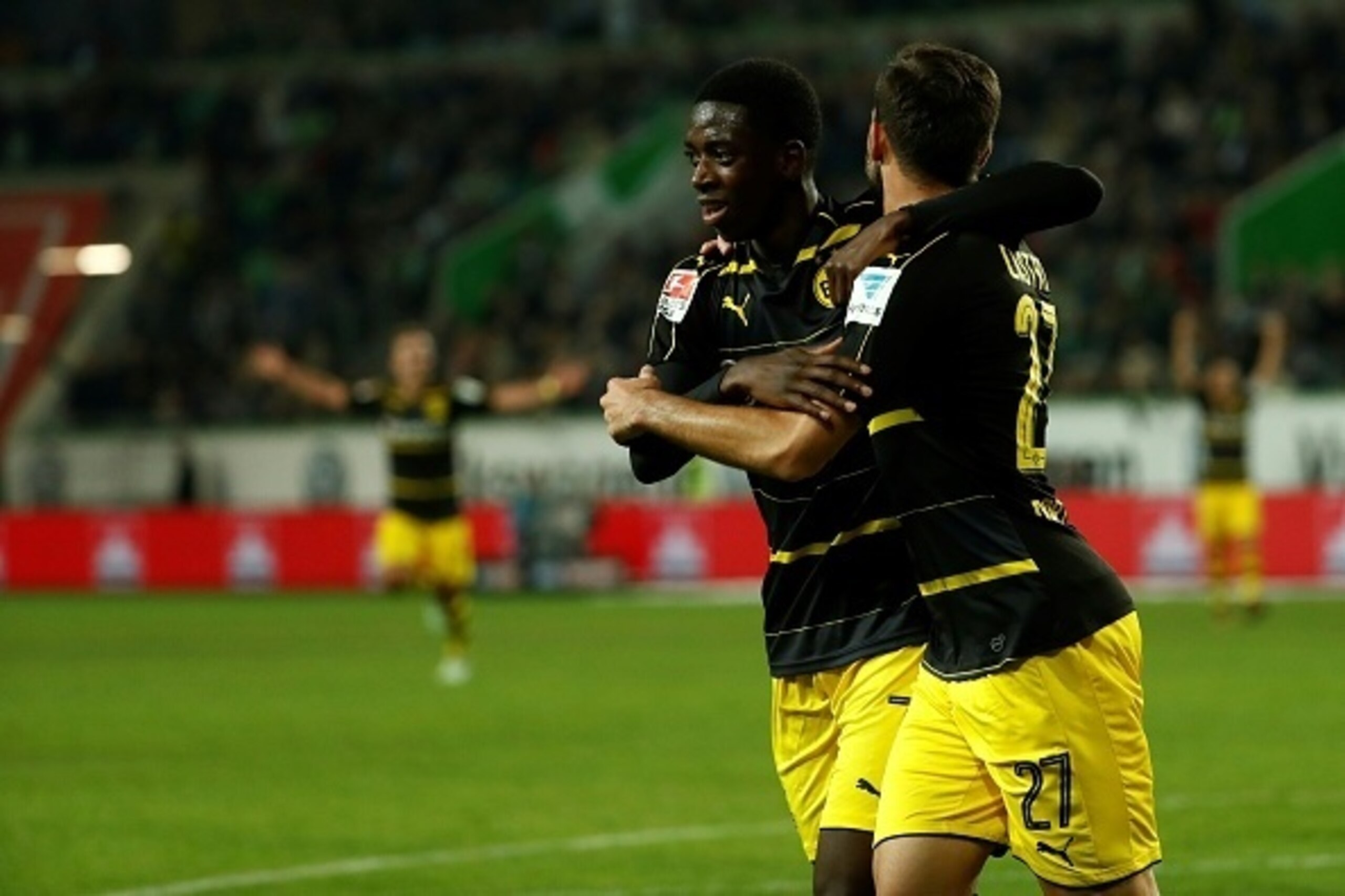 Dortmund's French midfielder Ousmane Dembele (L) and Dortmund's midfielder Gonzalo Castro celebrate during the German first division Bundesliga football match between VfL Wolfsburg and Borussia Dortmund at Volkswagen Arena in Wolfsburg, central Germany, o