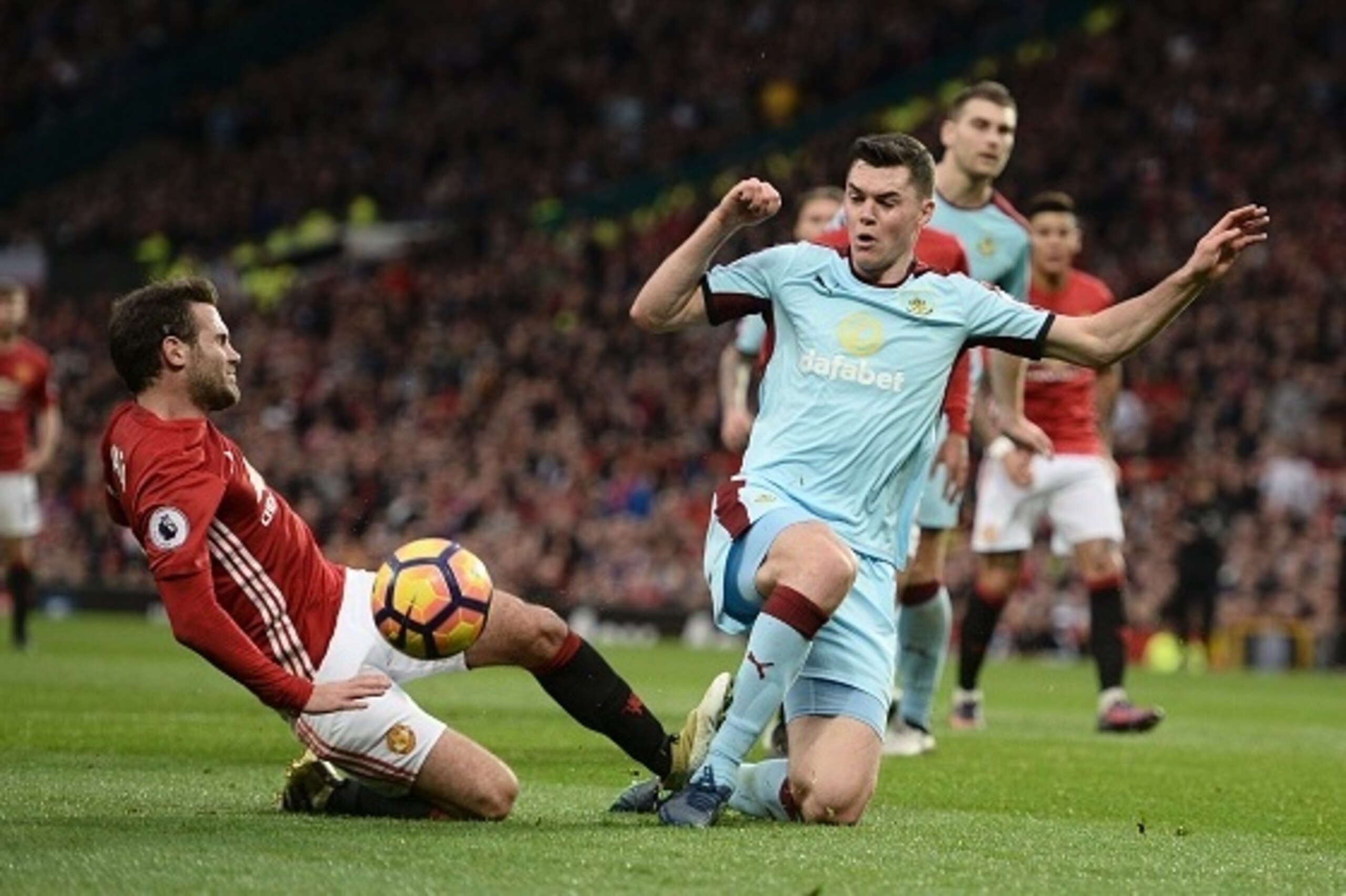 Burnley's English defender Michael Keane (R) stops Manchester United's Spanish midfielder Juan Mata (L) from shooting during the English Premier League football match between Manchester United and Burnley at Old Trafford in Manchester, north west England,