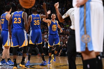 DENVER, CO - NOVEMBER 10:  Kevin Durant #35, and Stephen Curry #30 of the Golden State Warriors high five to celebrate during the game against the Denver Nuggets on November 10, 2016 at the Pepsi Center in Denver, Colorado. NOTE TO USER: User expressly ac