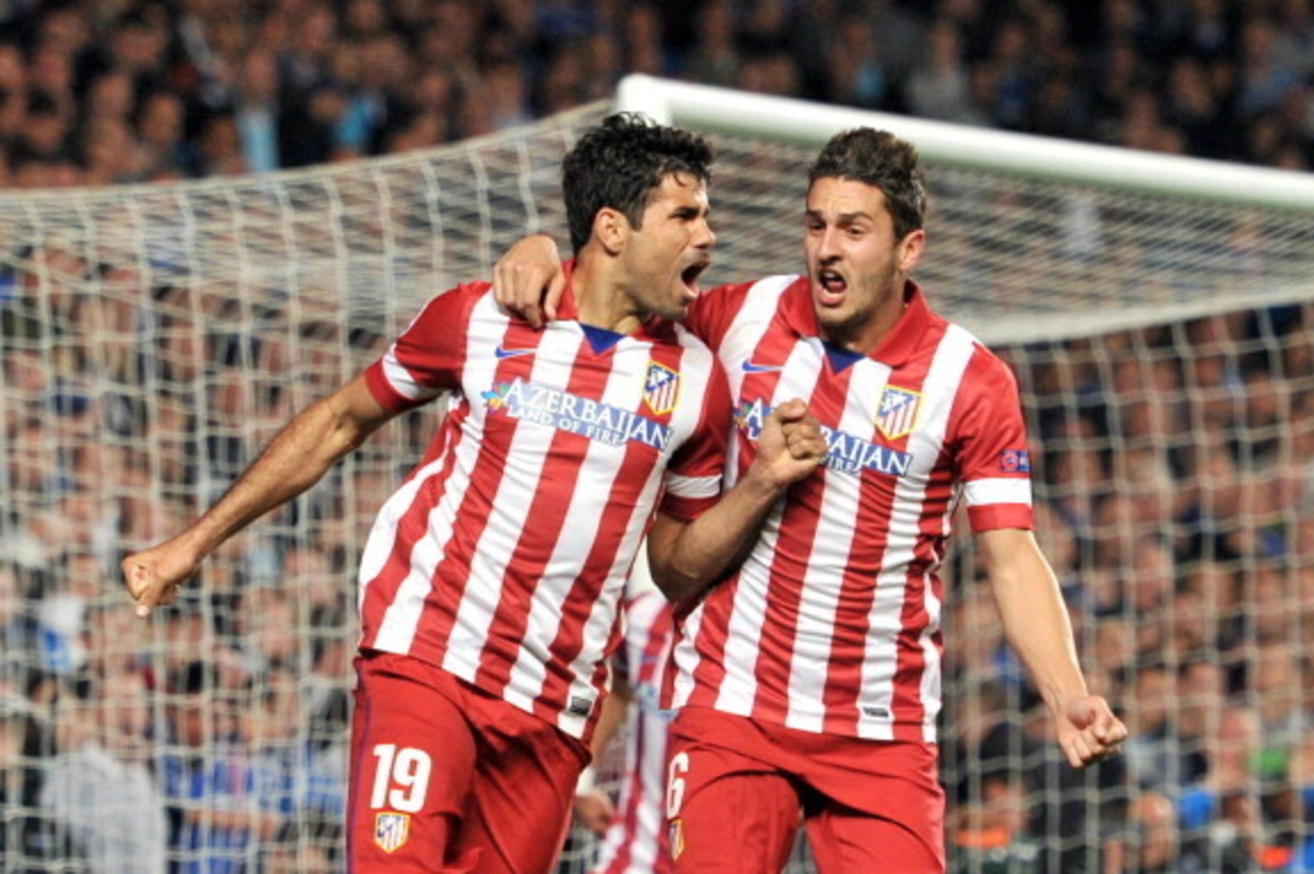 Atletico Madrid's Brazilian-born forward Diego da Silva Costa (L) celebrates scoring his team's second goal with Atletico Madrid's Spanish midfielder Koke during the UEFA Champions League semi-final second leg football match between Chelsea and Atletico M