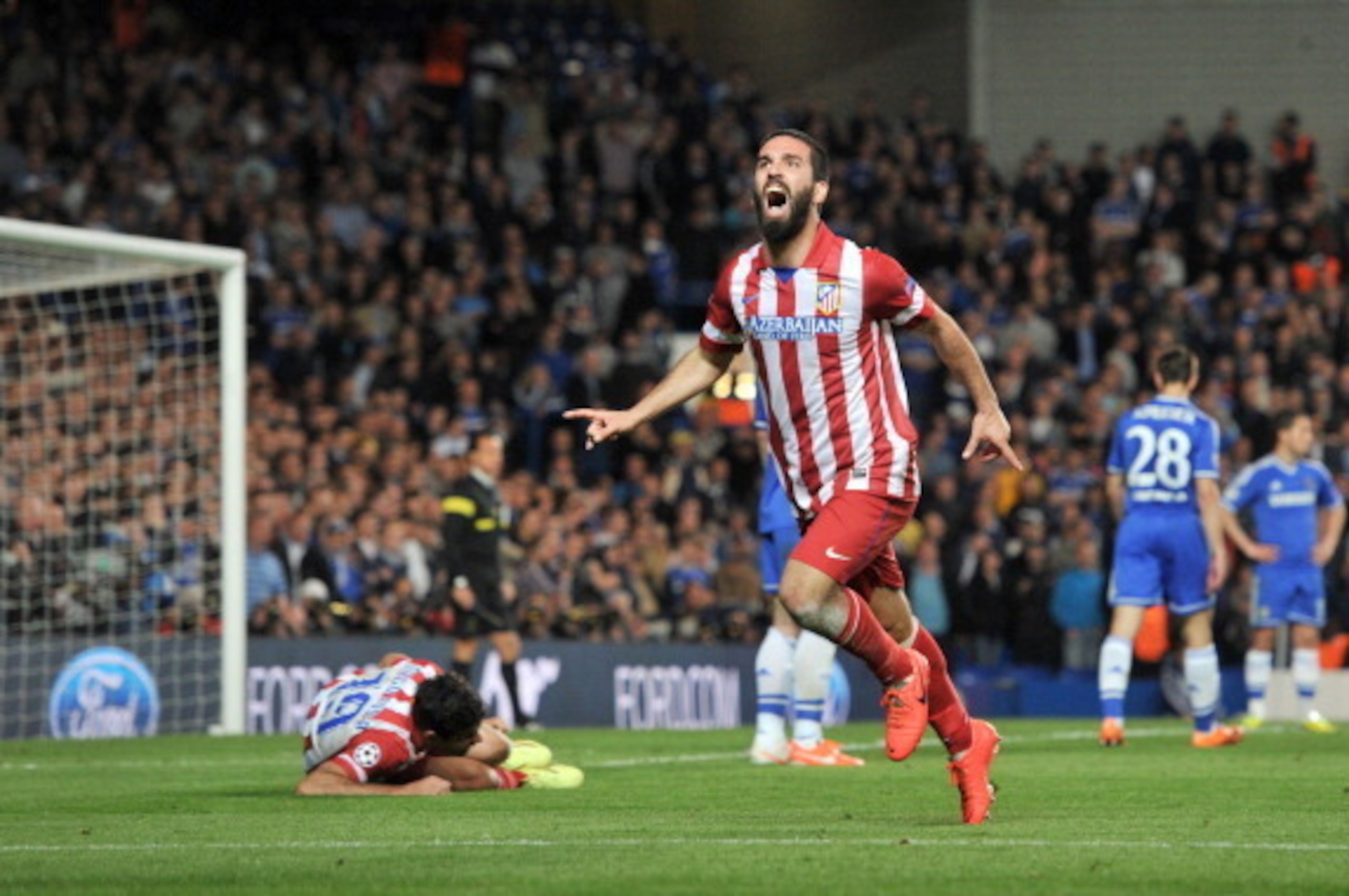 Atletico Madrid's Turkish midfielder Arda Turan celebrates scoring his team's third goal during the UEFA Champions League semi-final second leg football match between Chelsea and Atletico Madrid at Stamford Bridge in London on April 30, 2014.  AFP PHOTO /