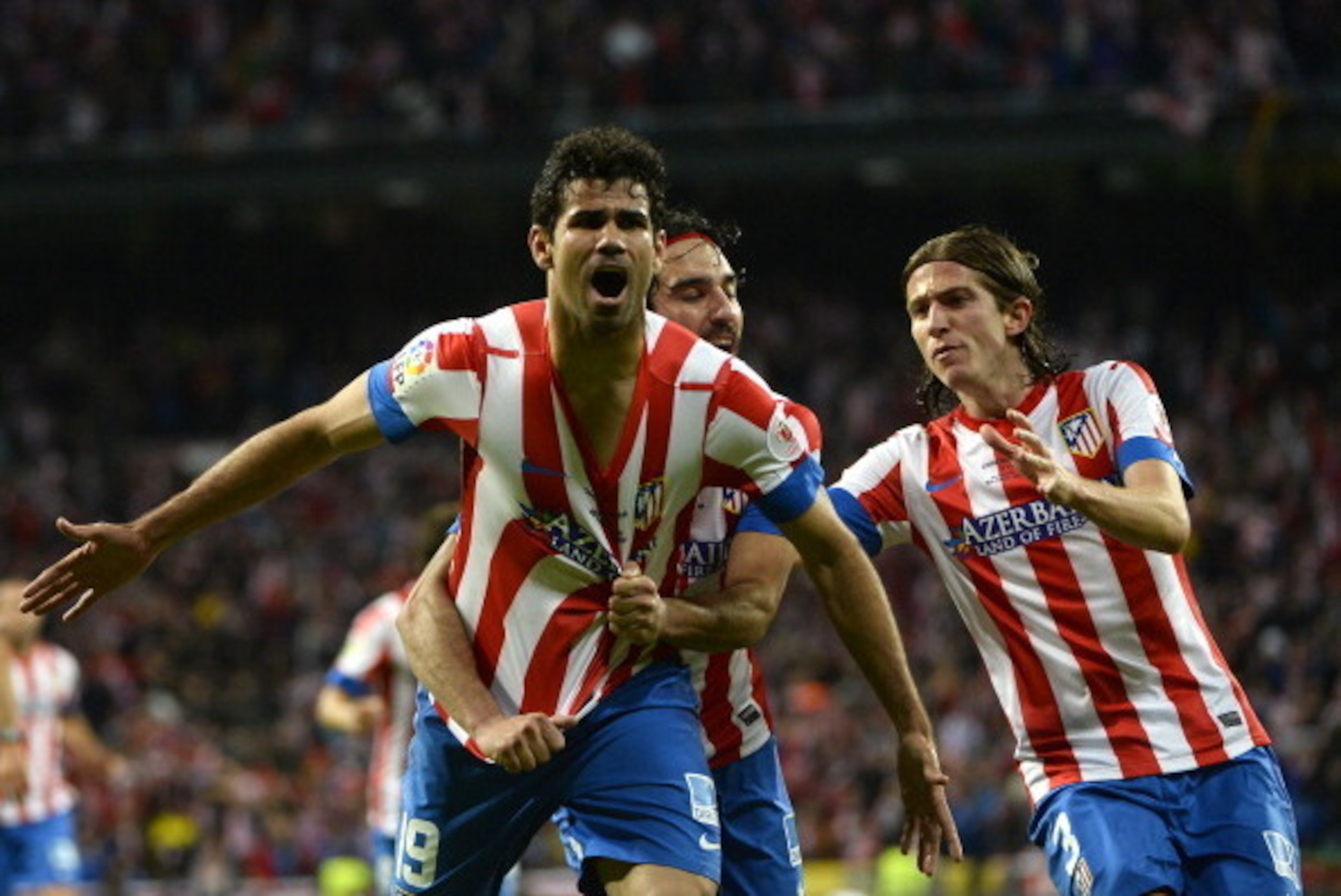 Atletico Madrid's Brazilian forward Diego da Silva Costa (L) celebrates with his teammate Turkish midfielder Arda Turan (C) and Brazilian defender Filipe Luis after scoring during the Spanish King's Cup (Copa del Rey) final football match Real Madrid vs A