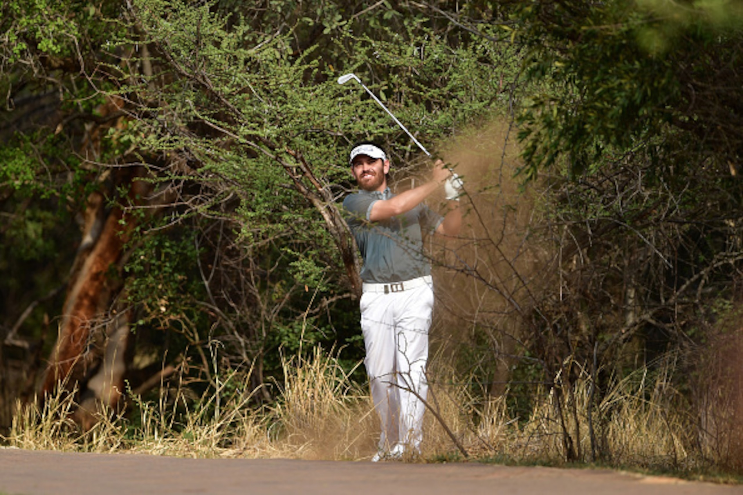 SUN CITY, SOUTH AFRICA - NOVEMBER 11:  Louis Oosthuizen of South Africa hits from the bushes during day two of the Nedbank Golf Challenge at Gary Player CC on November 11, 2016 in Sun City, South Africa.  (Photo by Stuart Franklin/Getty Images)