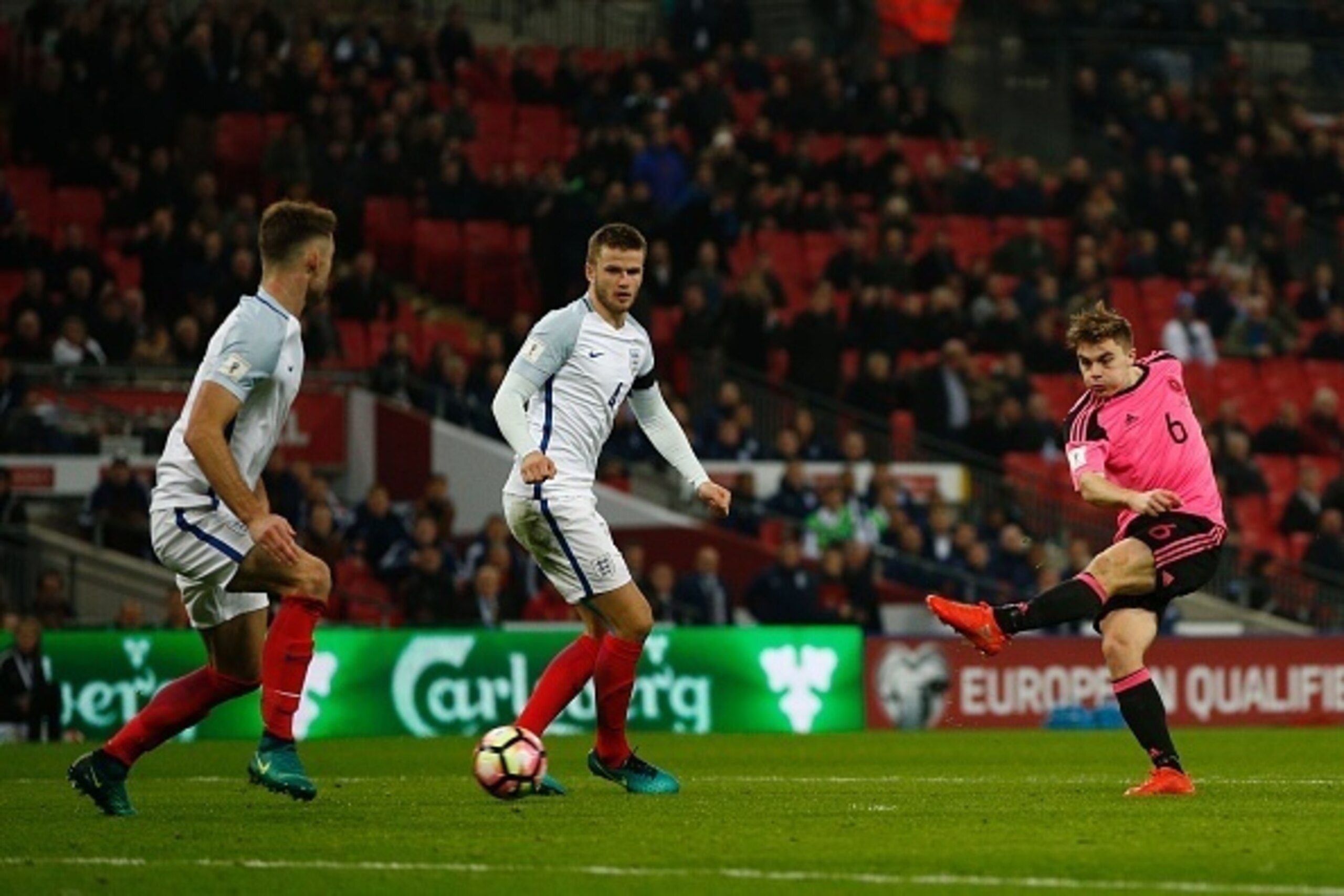 Scotland's defender James Forrest (R) misses a shot on goal during a World Cup 2018 qualification match between England and Scotland at Wembley stadium in London on November 11, 2016. / AFP / Adrian DENNIS / NOT FOR MARKETING OR ADVERTISING USE / RESTRICT