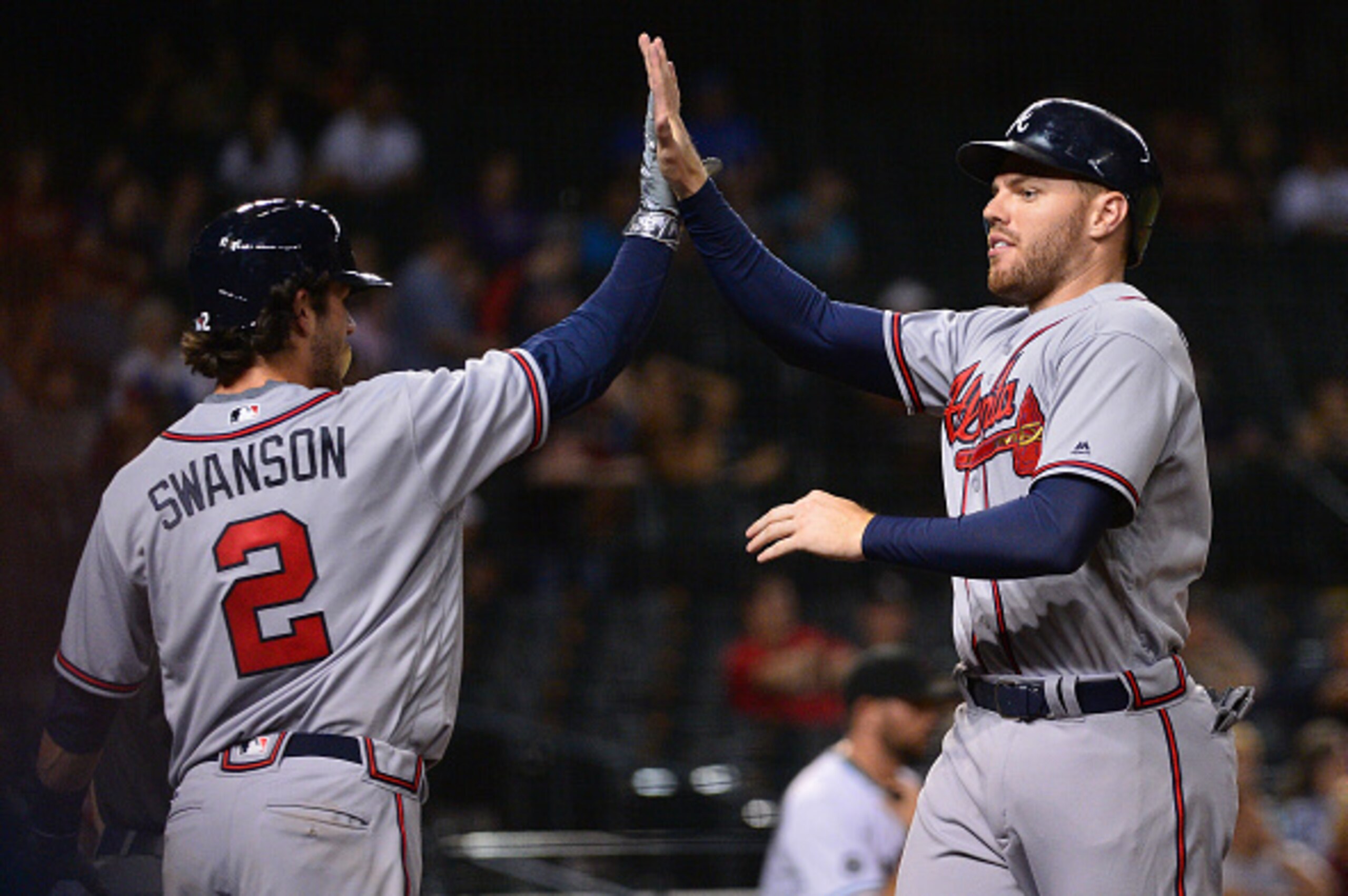 PHOENIX, AZ - AUGUST 23:  Freddie Freeman #5 and Dansby Swanson #2 of the Atlanta Braves celebrate after both scoring against the Arizona Diamondbacks in the eighth inning at Chase Field on August 23, 2016 in Phoenix, Arizona.  (Photo by Jennifer Stewart/