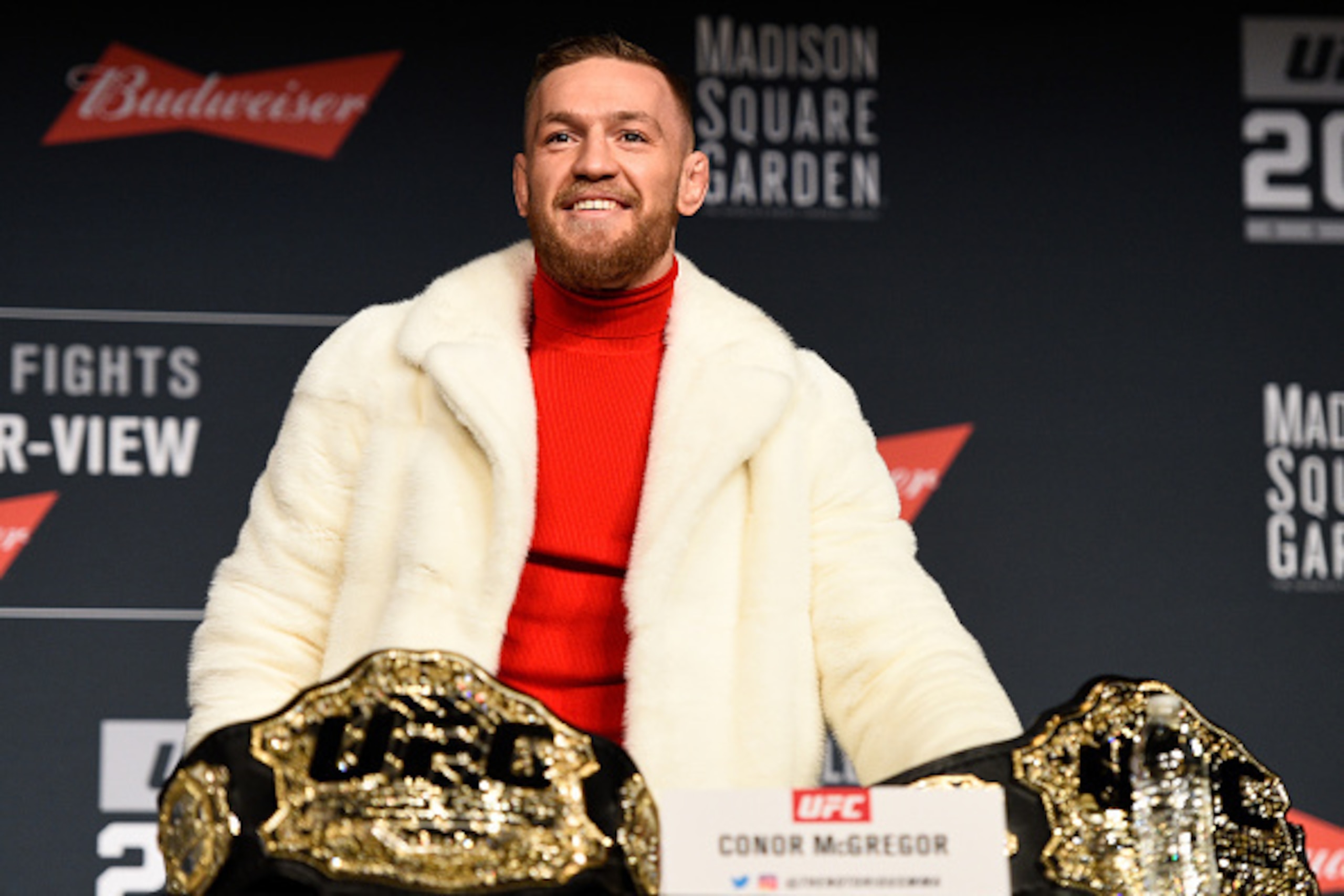NEW YORK, NY - NOVEMBER 10:  UFC featherweight champion Conor McGregor of Ireland takes the belt of lightweight champion Eddie Alvarez (not pictured) during the UFC 205 press conference inside The Theater at Madison Square Garden on November 10, 2016 in N