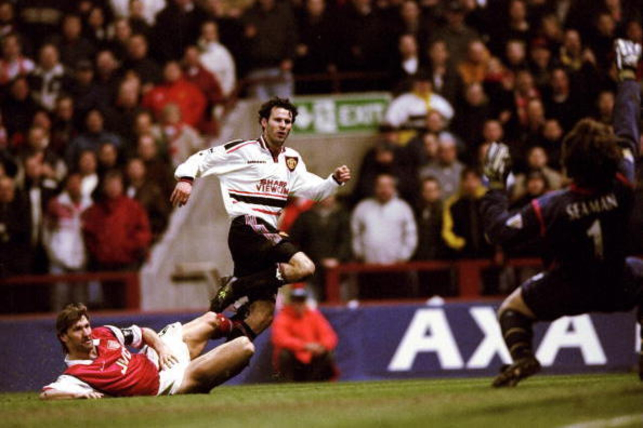 14 Apr 1999:  Ryan Giggs of Manchester United beats the despairing lunge of Tony Adams of Arsenal to drive the ball past David Seaman to score the winner in the FA Cup Semi Final match played at Villa Park in Birmingham. Manchester United won the game 2-1