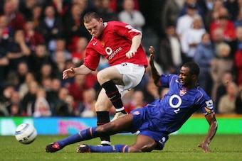 MANCHESTER, ENGLAND - OCTOBER 24: Wayne Rooney of Manchester United battles with Patrick Vieira of Arsenal during the FA Barclays Premiership match between Manchester United and Arsenal at Old Trafford on October 24, 2004 in Manchester, England.  (Photo b