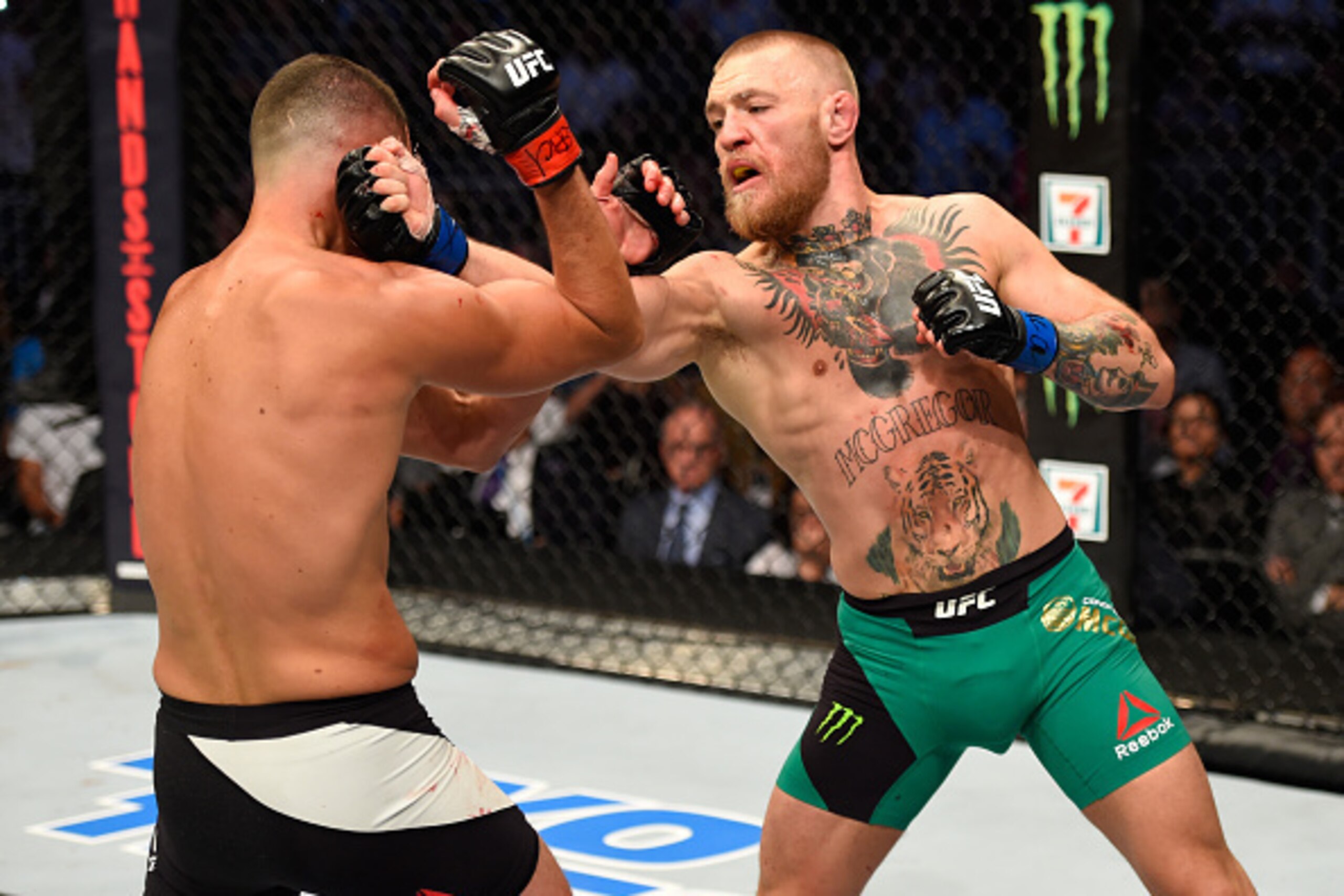 LAS VEGAS, NV - AUGUST 20:   (R-L) Conor McGregor of Ireland punches Nate Diaz in their welterweight bout during the UFC 202 event at T-Mobile Arena on August 20, 2016 in Las Vegas, Nevada. (Photo by Josh Hedges/Zuffa LLC/Zuffa LLC via Getty Images)