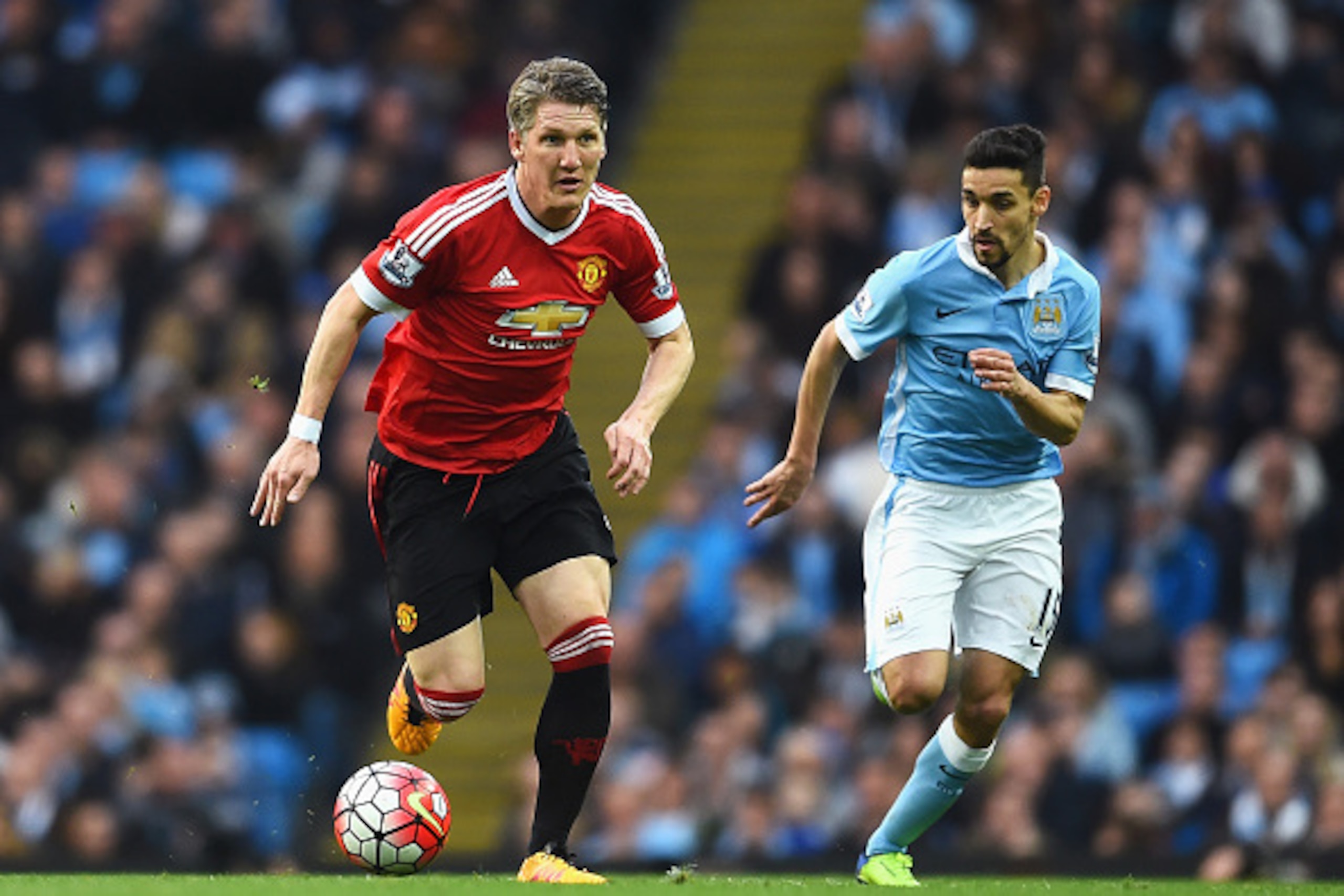 MANCHESTER, ENGLAND - MARCH 20: Bastian Schweinsteiger of Manchester United is chased by Jesus Navas of Manchester City during the Barclays Premier League match between Manchester City and Manchester United at Etihad Stadium on March 20, 2016 in Manchest MANCHESTER, ENGLAND - MARCH 20: Bastian Schweinsteiger of Manchester United is chased by Jesus Navas of Manchester City during the Barclays Premier League match between Manchester City and Manchester United at Etihad Stadium on March 20, 2016 in Manchest