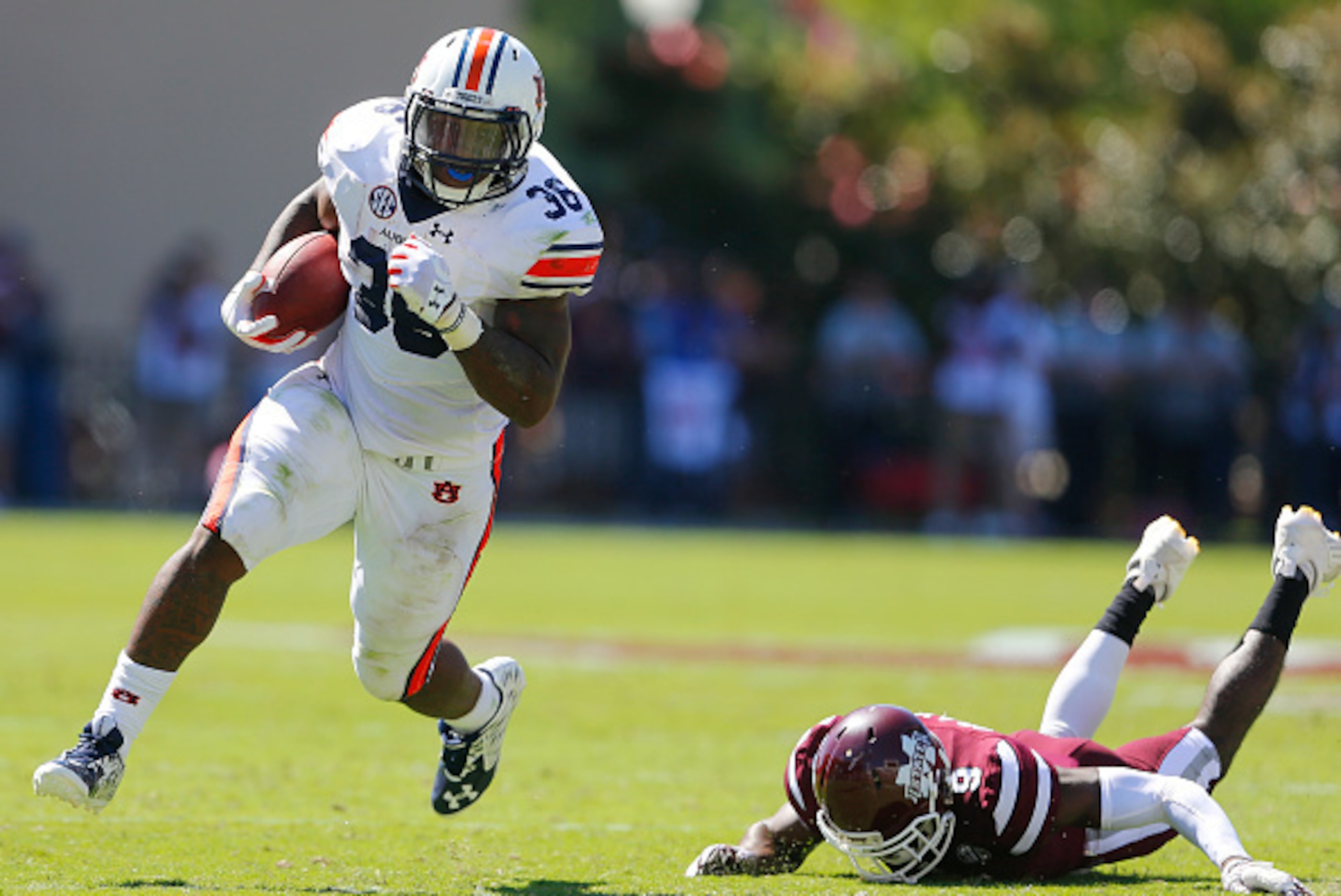 STARKVILLE, MS - OCTOBER 8:   Running back Kamryn Pettway #36 of the Auburn Tigers tries to get around defensive back Jamoral Graham #9 of the Mississippi State Bulldogs as he carries the ball during the first half of an NCAA college football game on Oct.