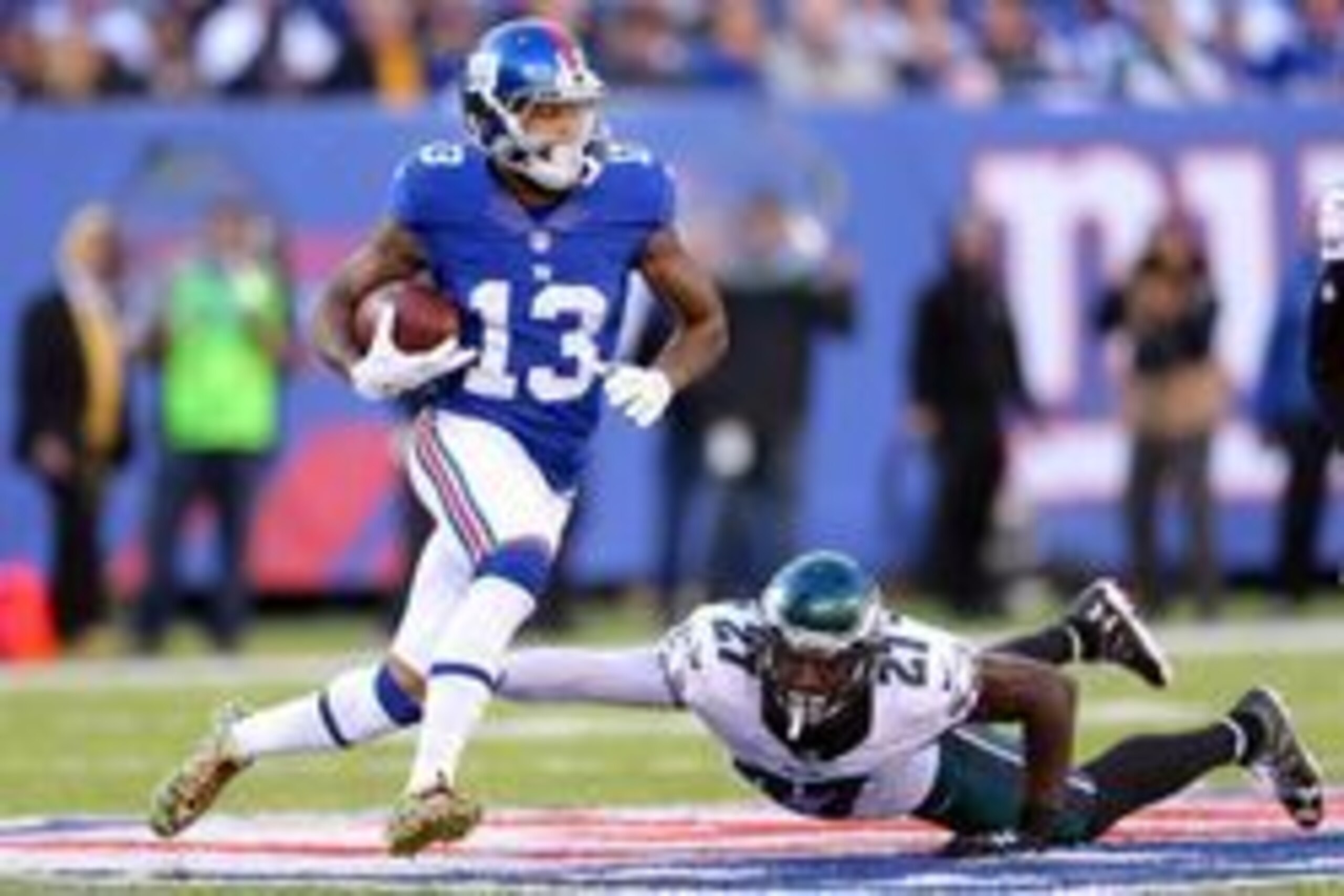 Nov 6, 2016; East Rutherford, NJ, USA; New York Giants wide receiver Odell Beckham Jr. (13) runs the ball past Philadelphia Eagles safety Malcolm Jenkins (27) during the third quarter at MetLife Stadium. Mandatory Credit: Brad Penner-USA TODAY Sports