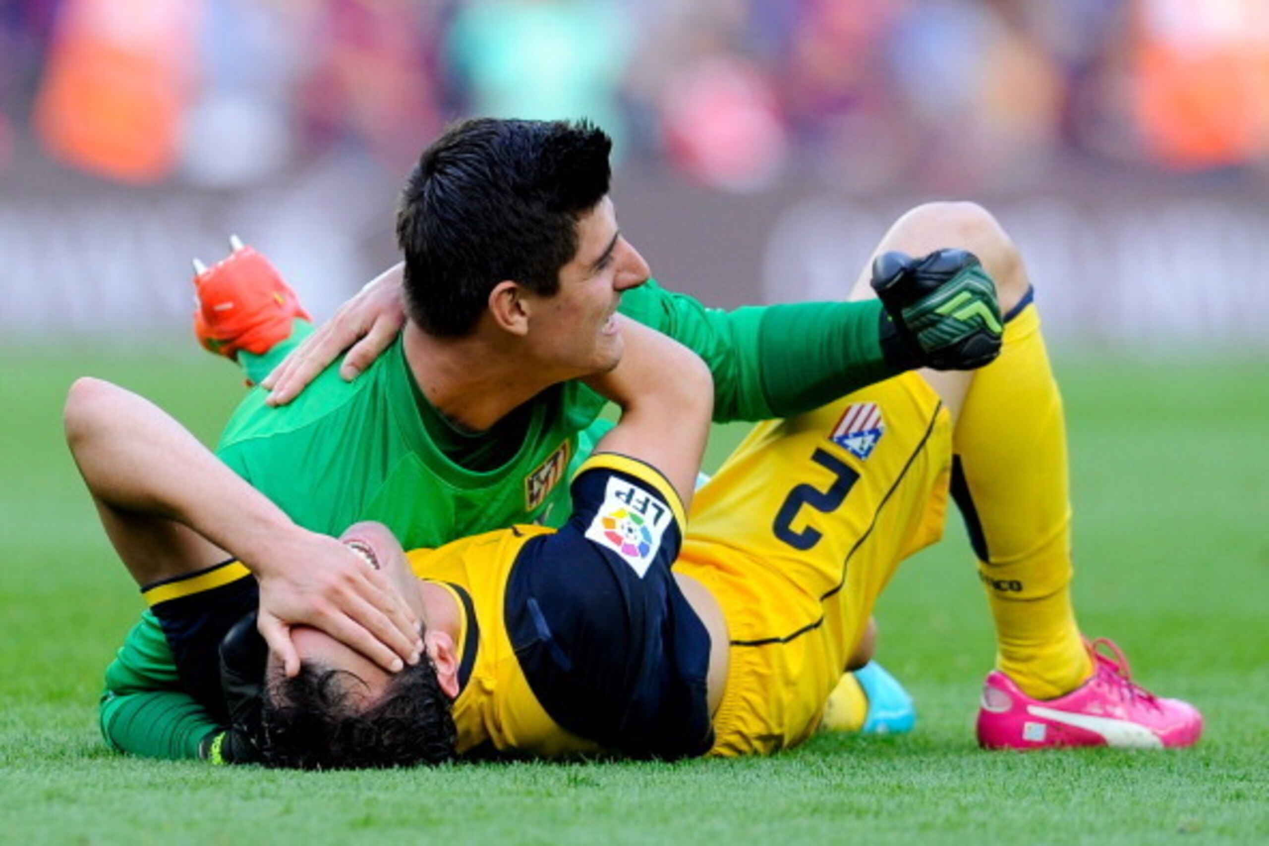 BARCELONA, SPAIN - MAY 17:  Thibaut Courtois of Atletico de Madrid celebrates with his teammate Diego Godin of Atletico de Madrid at the end of the La Liga match between FC Barcelona and Club Atletico de Madrid at Camp Nou on May 17, 2014 in Barcelona, Sp