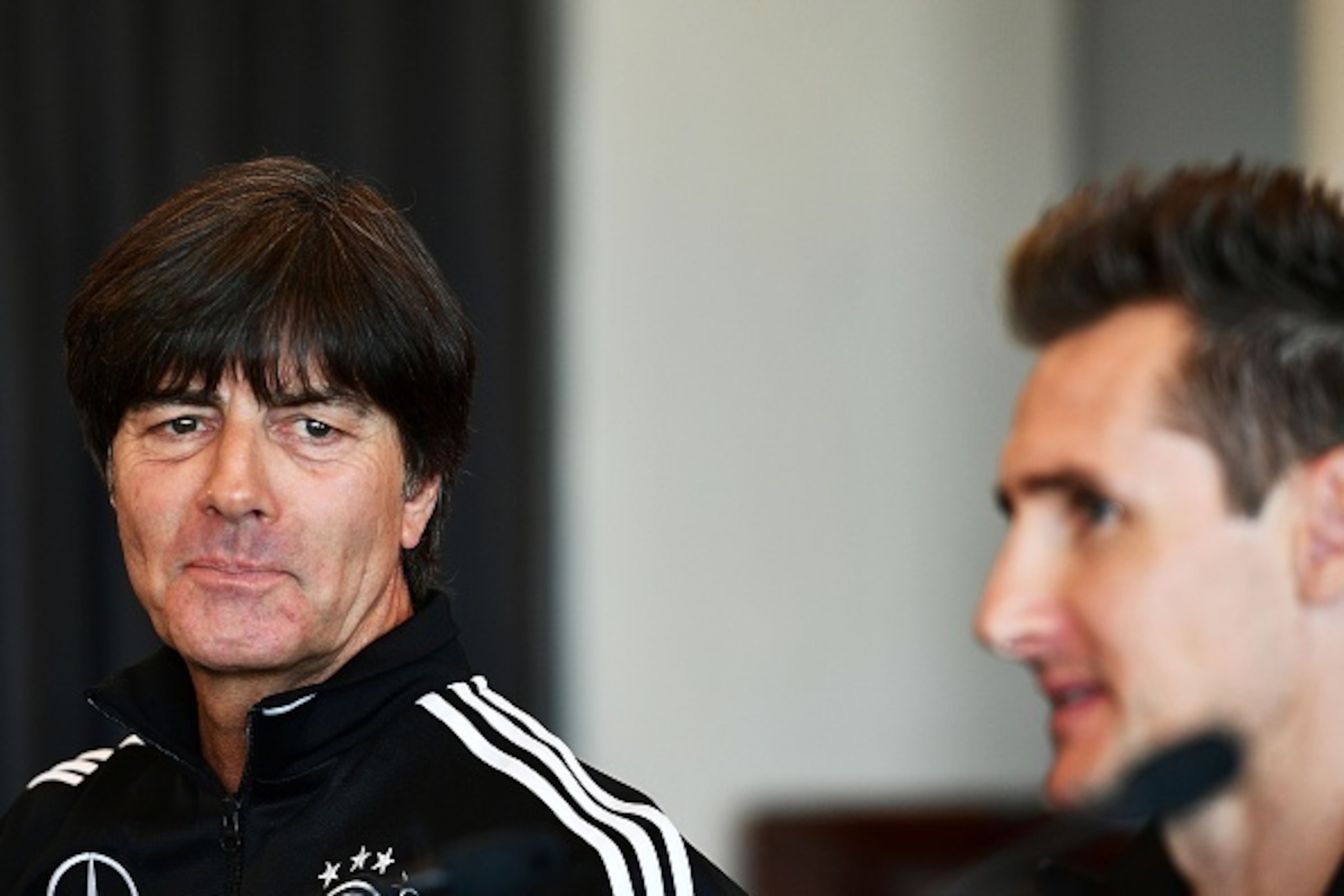 German team coach Joachim Low (L) smiles next to assistant coach Miroslav Klose, during a press conference on November 10, 2016 in Rimini, on the eve of the FIFA World Cup 2018 qualifying football match against San Marino. / AFP / VINCENZO PINTO        (P