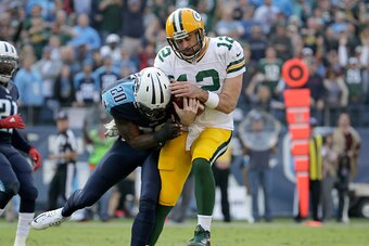 NASHVILLE, TN - NOVEMBER 13:  Aaron Rodgers #12 of the Green Bay Packers is hit by Perrish Cox #20 of the Tennessee Titans after he scores a touchdown during the game at Nissan Stadium on November 13, 2016 in Nashville, Tennessee.  (Photo by Andy Lyons/Ge