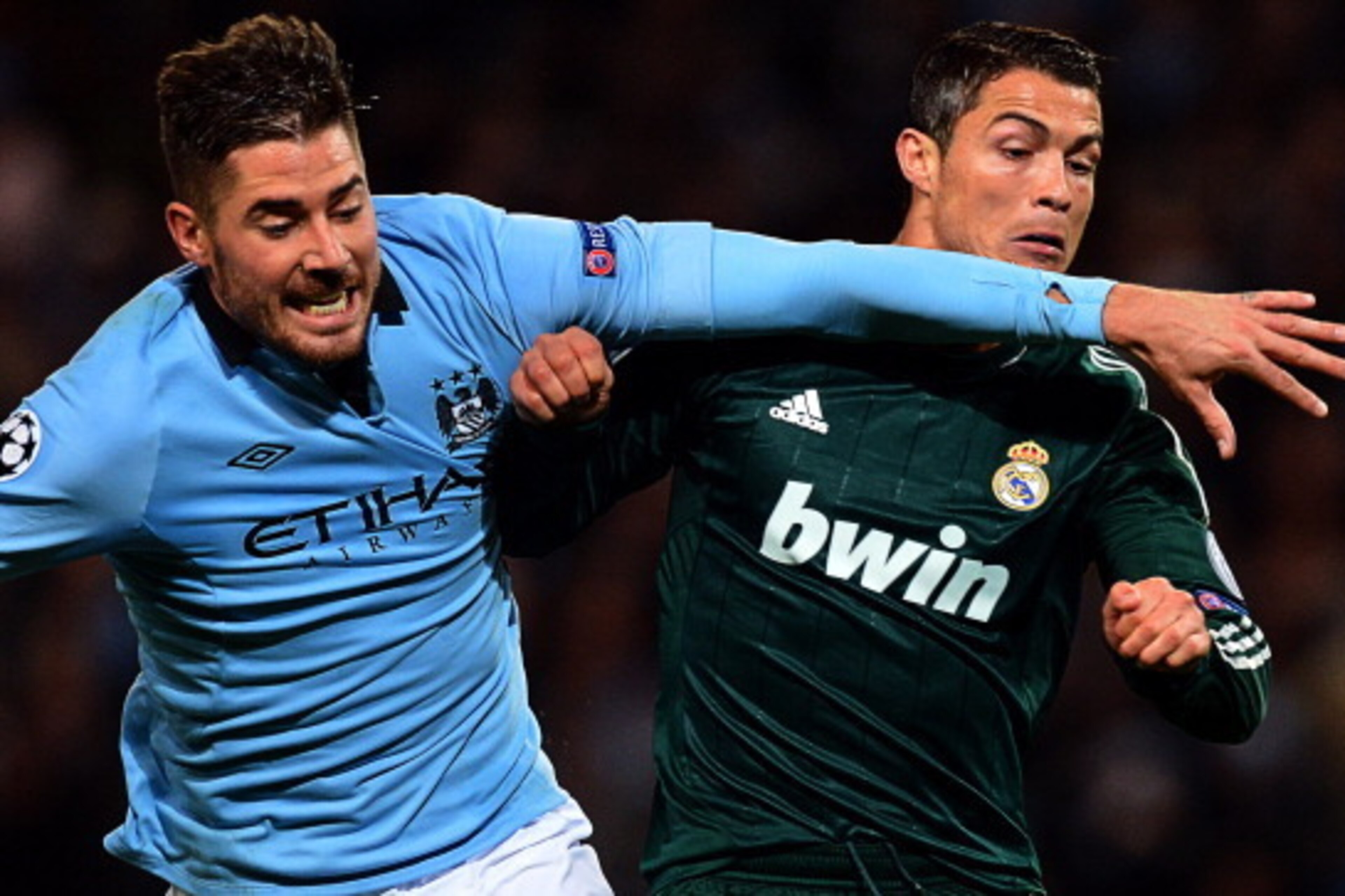Real Madrid's Portuguese forward Cristiano Ronaldo (R) vies with Manchester City's Spanish midfielder Javi Garcia during the UEFA Champions League group D football match between Manchester City and Real Madrid at The Etihad Stadium in Manchester, north-we