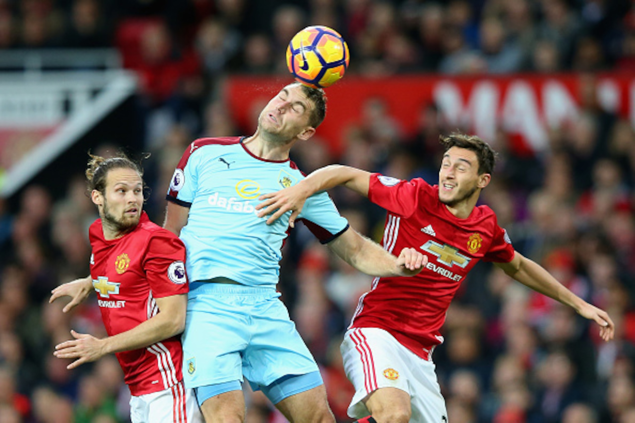MANCHESTER, ENGLAND - OCTOBER 29: Scott Arfield (C) of Burnley competes against Daley Blind (L) and Matteo Darmian (R) of Manchester United during the Premier League match between Manchester United and Burnley at Old Trafford on October 29, 2016 in Manche MANCHESTER, ENGLAND - OCTOBER 29: Scott Arfield (C) of Burnley competes against Daley Blind (L) and Matteo Darmian (R) of Manchester United during the Premier League match between Manchester United and Burnley at Old Trafford on October 29, 2016 in Manche