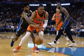 Nov 13, 2016; Oklahoma City, OK, USA; Orlando Magic guard Elfrid Payton (4) fouls Oklahoma City Thunder guard Russell Westbrook (0) during the fourth quarter at Chesapeake Energy Arena. Mandatory Credit: Mark D. Smith-USA TODAY Sports