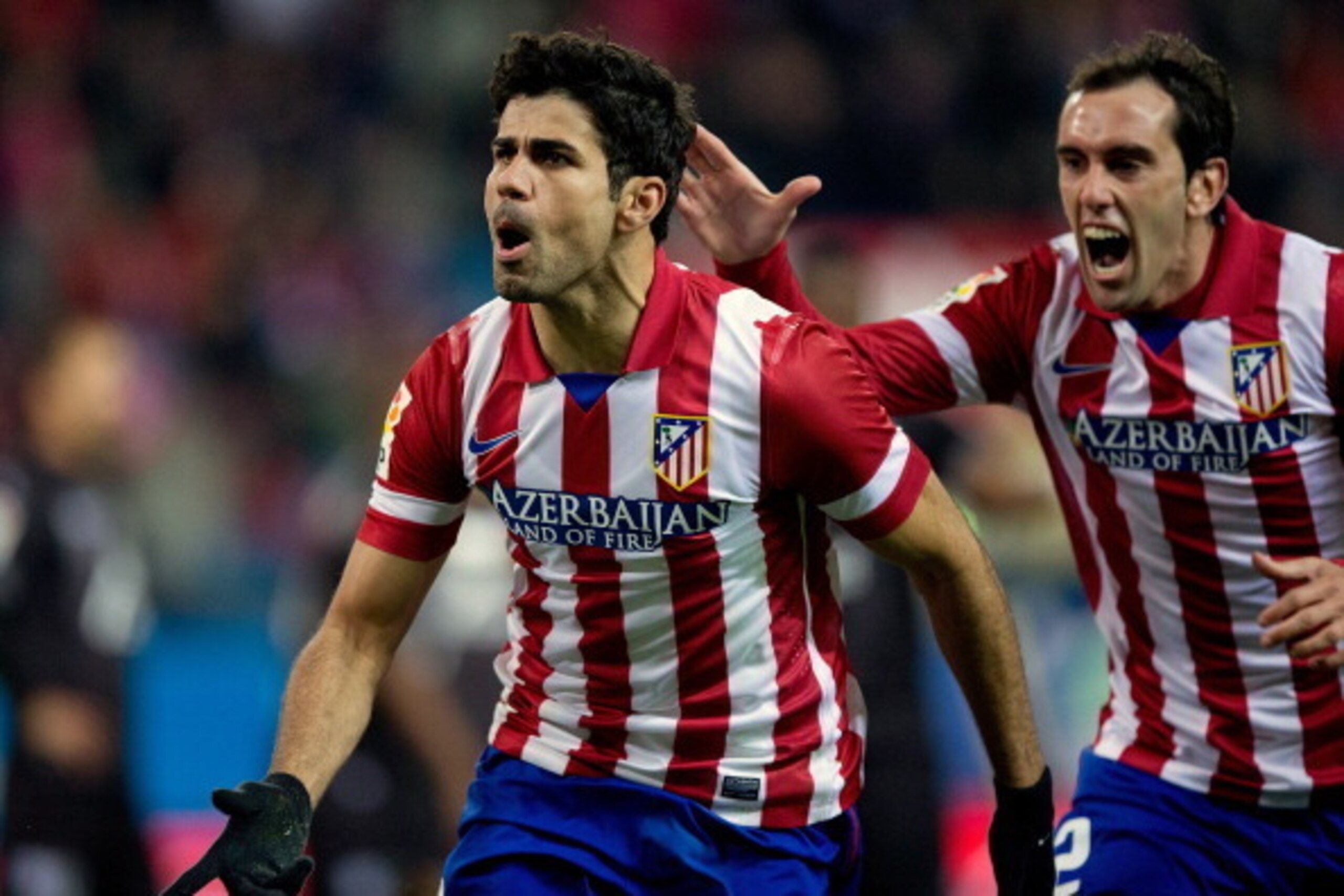 MADRID, SPAIN - DECEMBER 21:  Diego Costa (L) of Atletico de Madrid celebrates scoring their second goal with team-mate Diego Godin (R) during the La Liga match between Club Atletico de Madrid and Levante UD at Vicente Calderon Stadium on December 21, 201