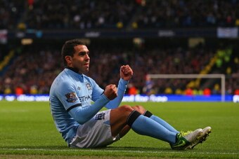 MANCHESTER, ENGLAND - NOVEMBER 17:  Carlos Tevez of Manchester City celebrates scoring his team's third goal from the penalty spot, to make the score 3-0 during the Barclays Premier League match between Manchester City and Aston Villa at the Etihad Stadiu