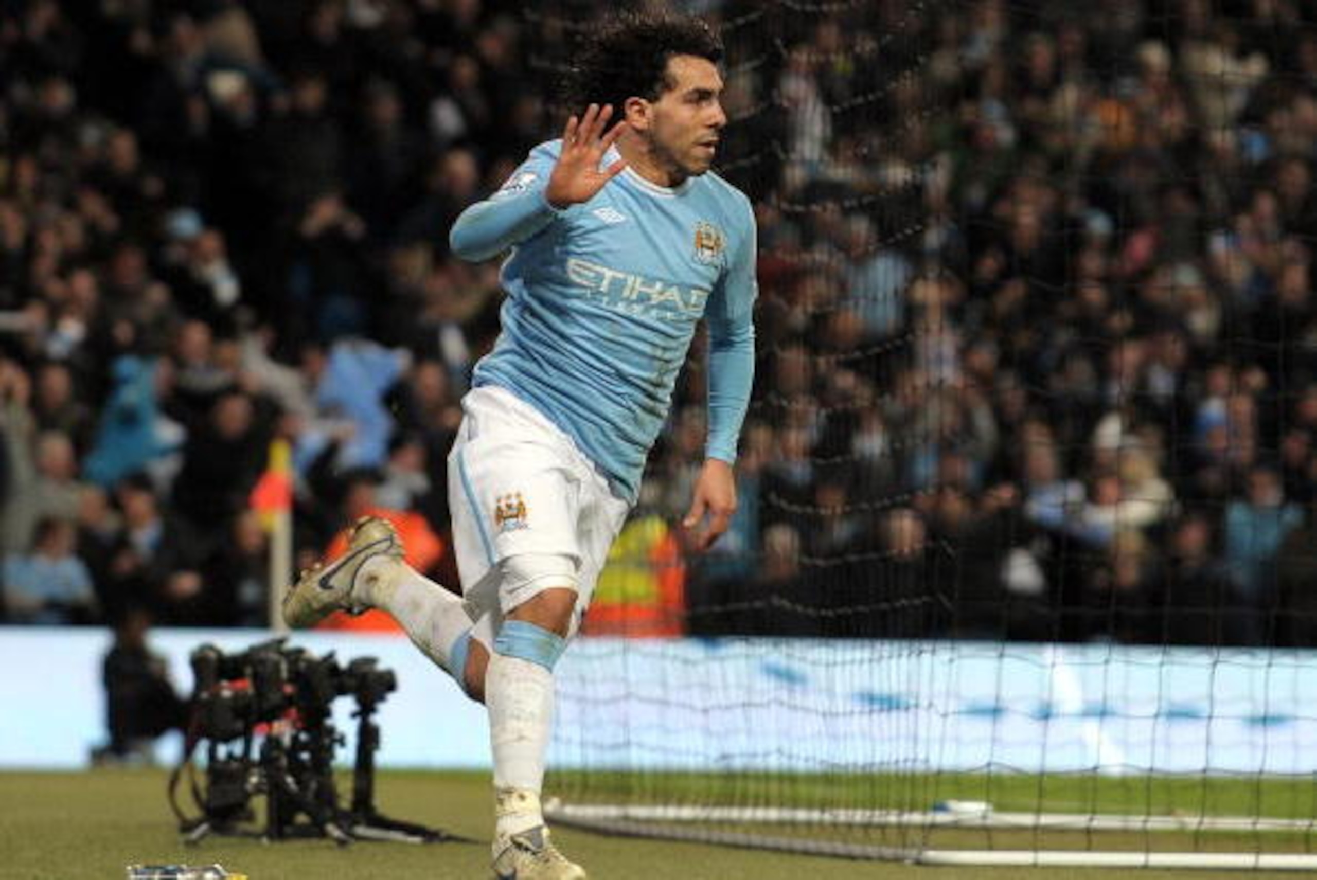 Manchester City's Argentinian forward Carlos Tevez celebrates scoring his second goal against Manchester United during their English League Cup semi final first leg football match at The City of Manchester Stadium in Manchester, north-west England, on Jan