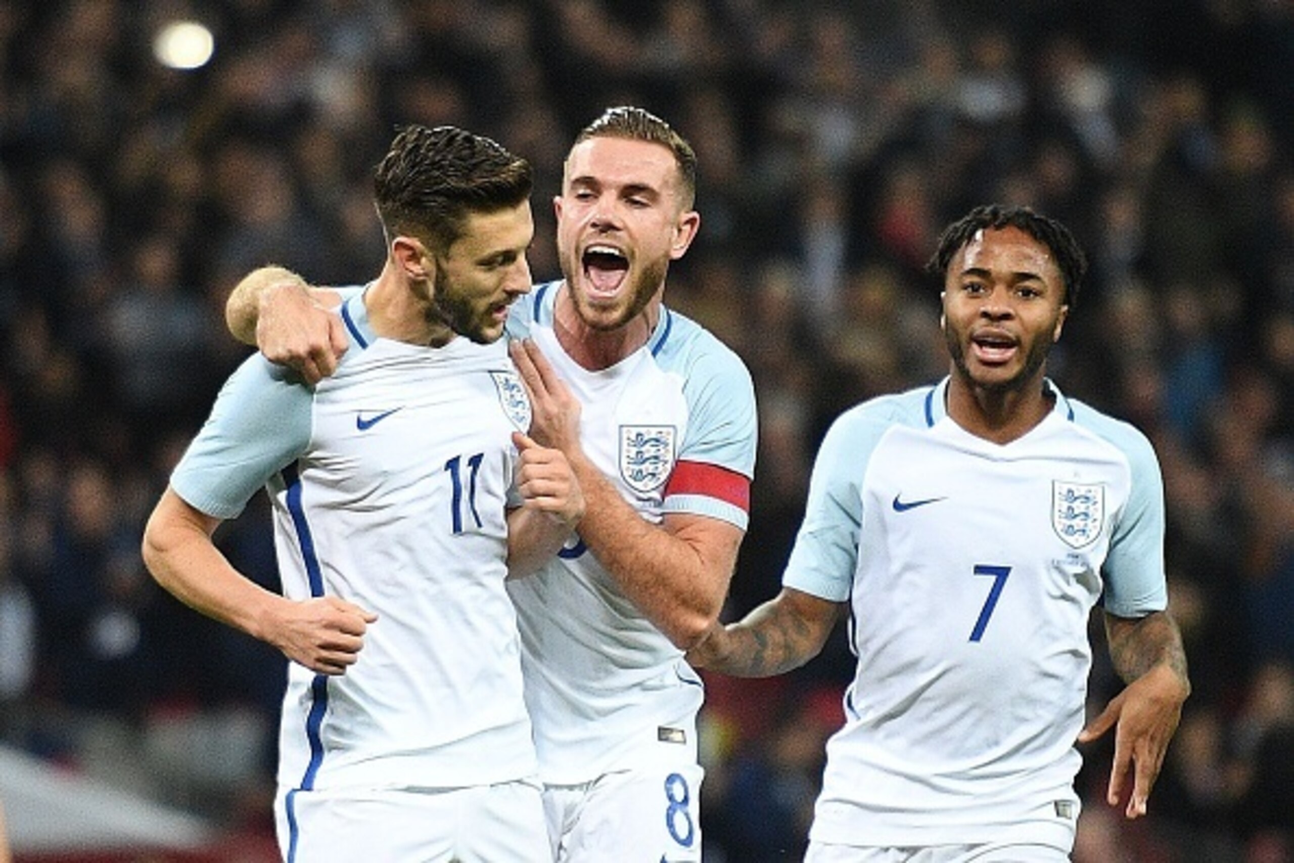 England's midfielder Adam Lallana (L) celebrates scoring his team's first goal from the penalty spot with England's midfielder Jordan Henderson (C) and England's midfielder Raheem Sterling during the friendly international football match between England a England's midfielder Adam Lallana (L) celebrates scoring his team's first goal from the penalty spot with England's midfielder Jordan Henderson (C) and England's midfielder Raheem Sterling during the friendly international football match between England a
