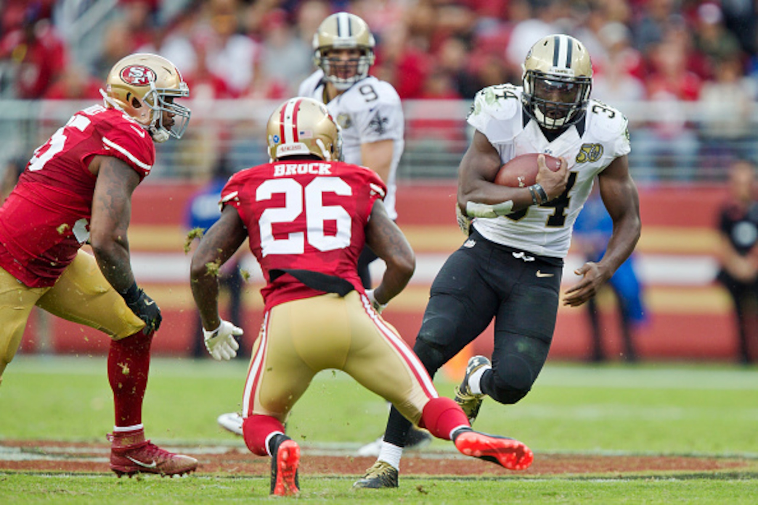SANTA CLARA, CA - NOVEMBER 6:  Running back Tim Hightower #34 of the New Orleans Saints runs for five yards against cornerback Tramaine Brock #26 of the San Francisco 49ers in the third quarter on November, 6 2016 at Levi's Stadium in Santa Clara, Califor