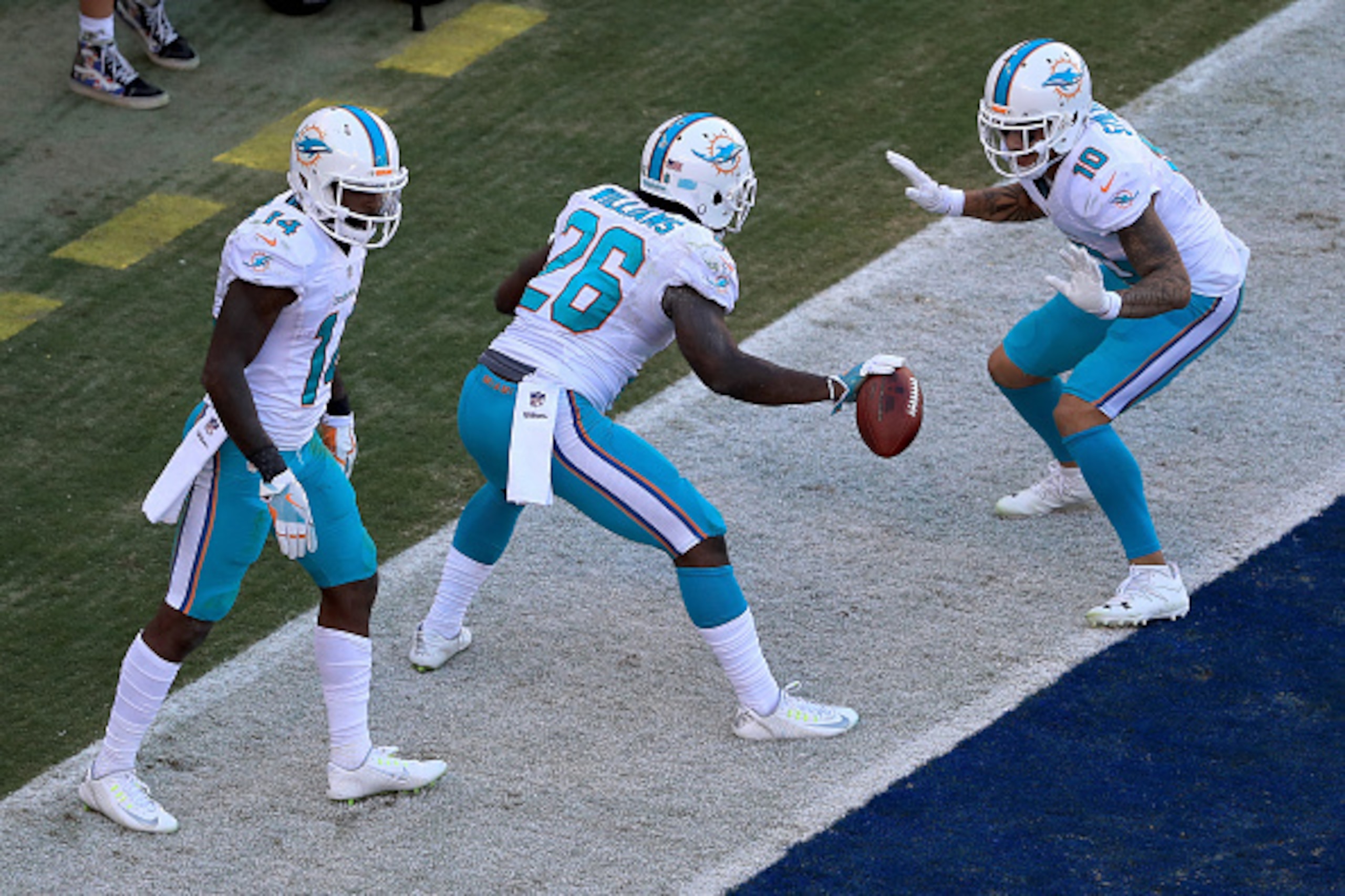 SAN DIEGO, CA - NOVEMBER 13:   Damien Williams #26,  Kenny Stills #10, and  Jarvis Landry #14 of the Miami Dolphins react after a touchdown during the second half of a game against the San Diego Chargers  at Qualcomm Stadium on November 13, 2016 in San Di
