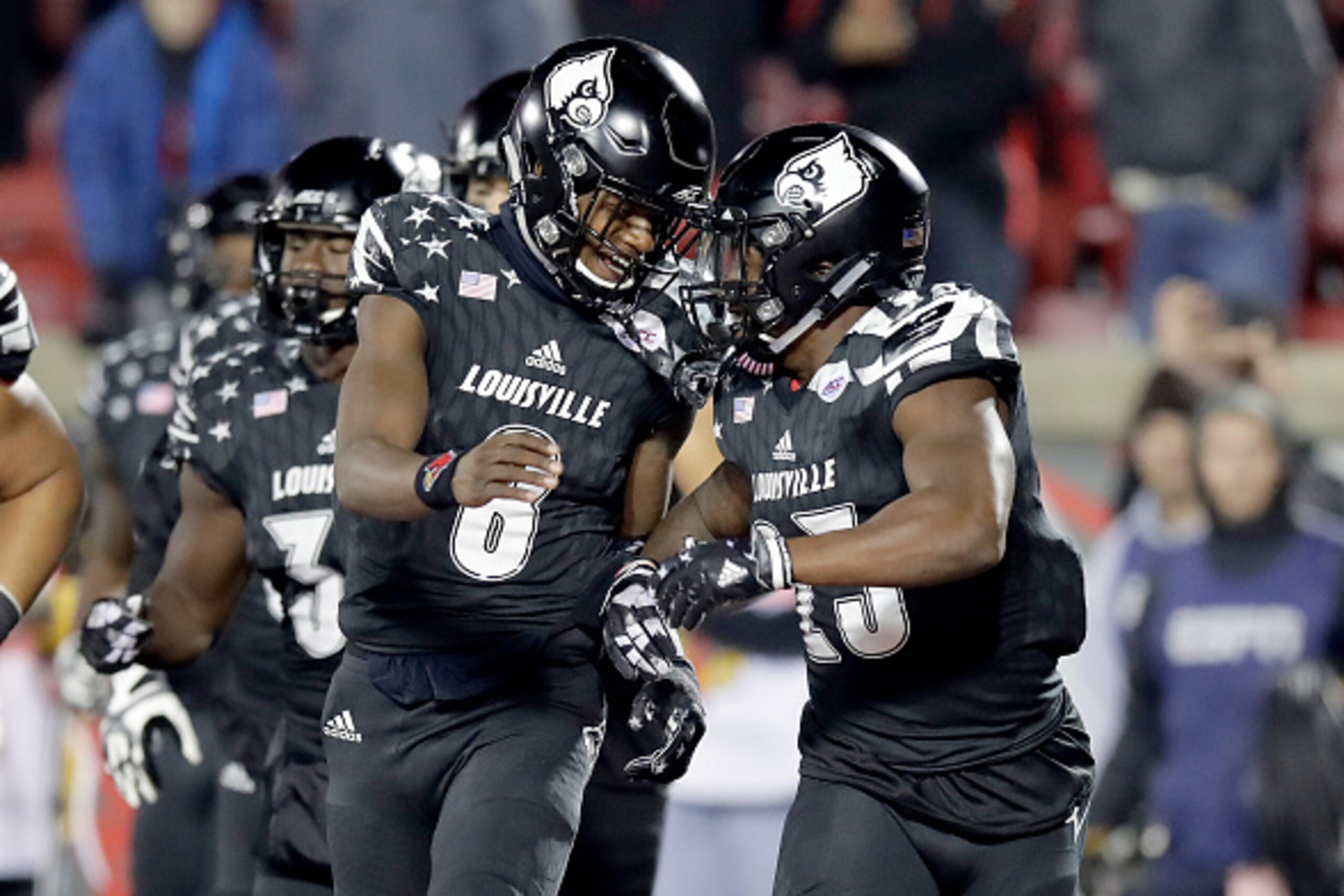 LOUISVILLE, KY - NOVEMBER 12:  Lamar Jackson #8 and Brandon Radcliff #23 of the Louisville Cardinals celebrate after Radcliff ran for a touchdown during the game against the Wake Forest Deamon Deacons at Papa John's Cardinal Stadium on November 12, 2016 i