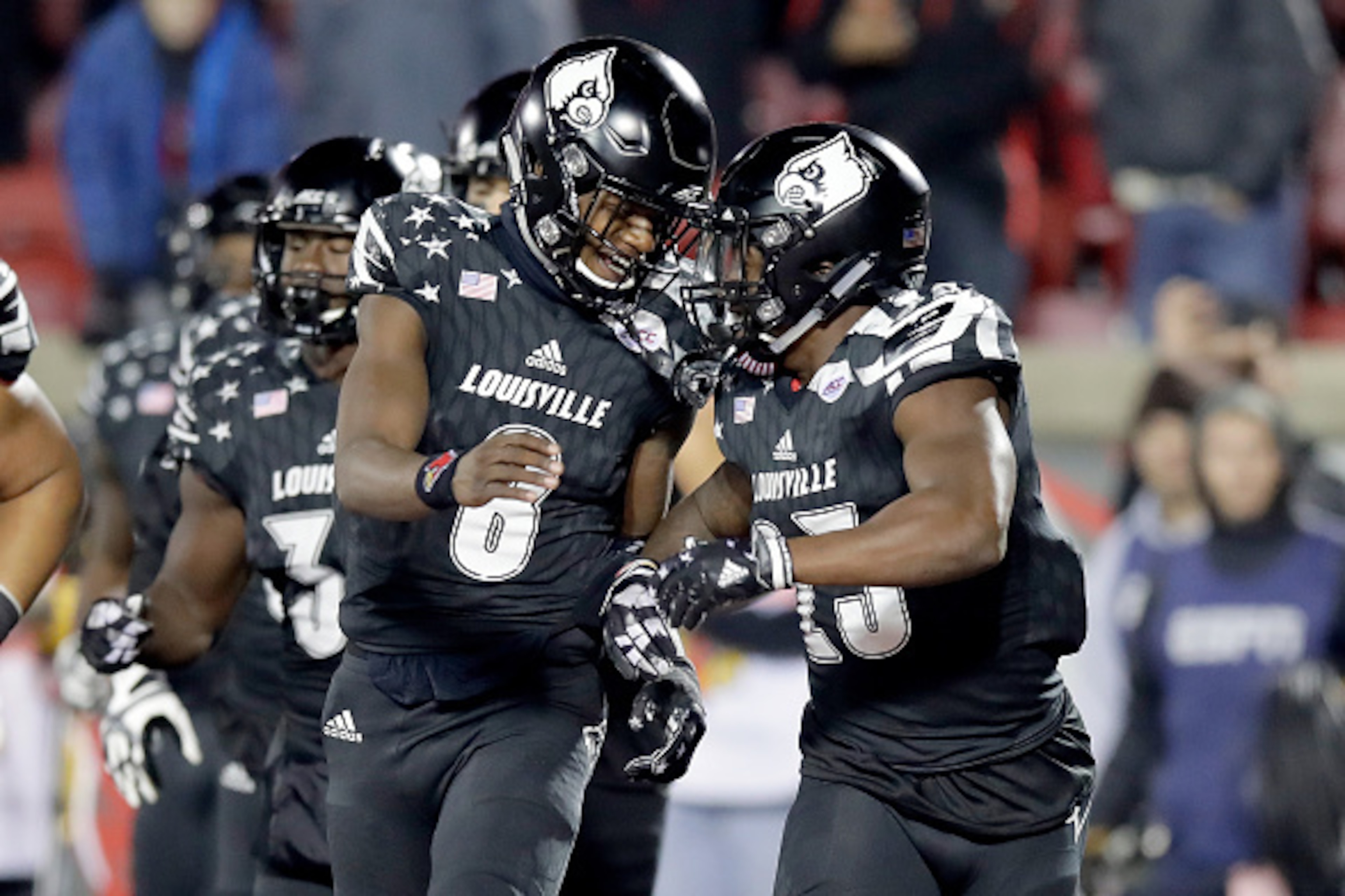 LOUISVILLE, KY - NOVEMBER 12: Lamar Jackson #8 and Brandon Radcliff #23 of the Louisville Cardinals celebrate after Radcliff ran for a touchdown during the game against the Wake Forest Deamon Deacons at Papa John's Cardinal Stadium on November 12, 2016 i LOUISVILLE, KY - NOVEMBER 12: Lamar Jackson #8 and Brandon Radcliff #23 of the Louisville Cardinals celebrate after Radcliff ran for a touchdown during the game against the Wake Forest Deamon Deacons at Papa John's Cardinal Stadium on November 12, 2016 i