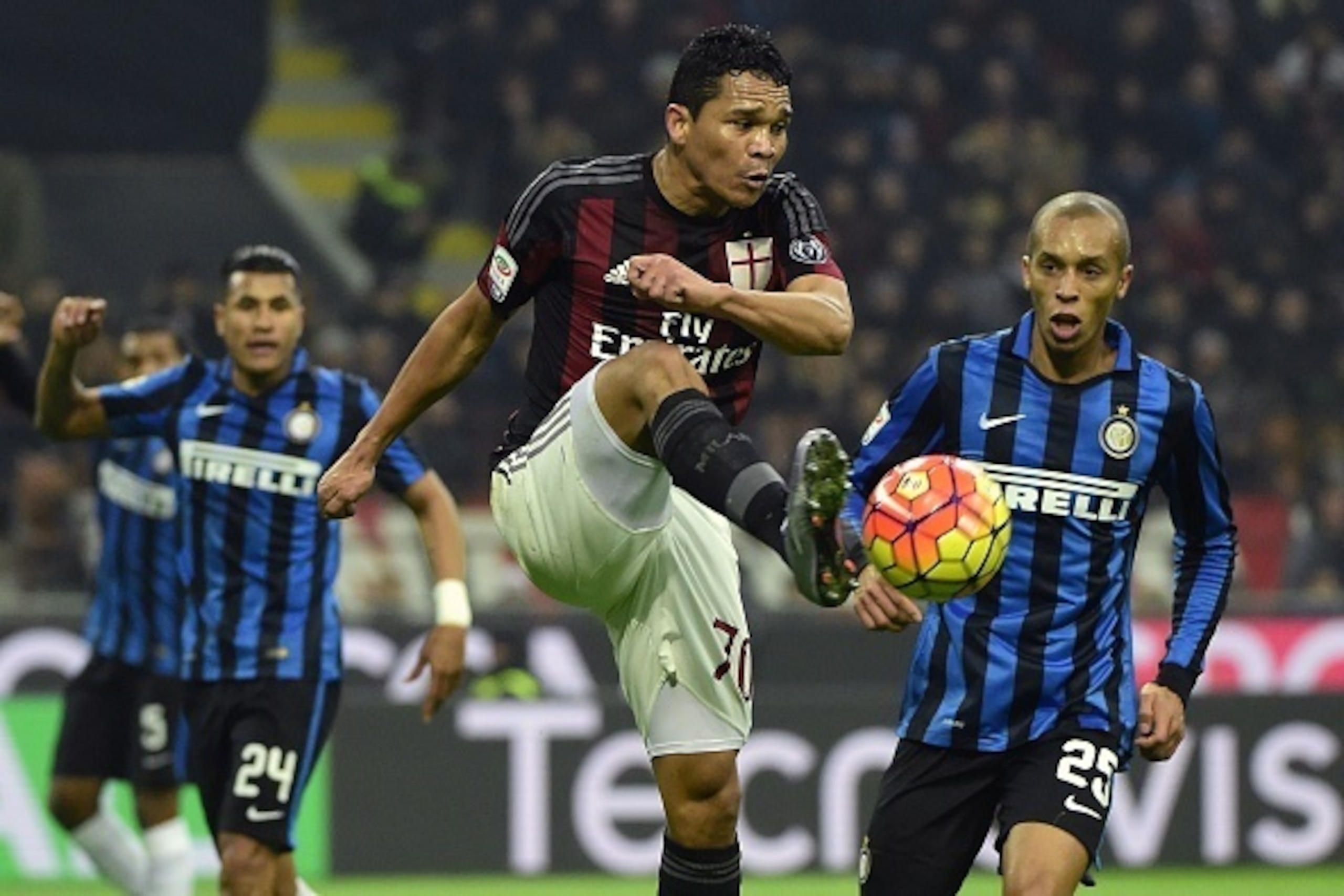 AC Milan's Colombian forward Carlos Bacca(C) vies for the ball with  Inter Milan's Brazilian defender Joao Miranda (R) during the Italian Serie A football match between AC Milan and Inter Milan on January 31, 2016 at the San Siro Stadium stadium in Milan.