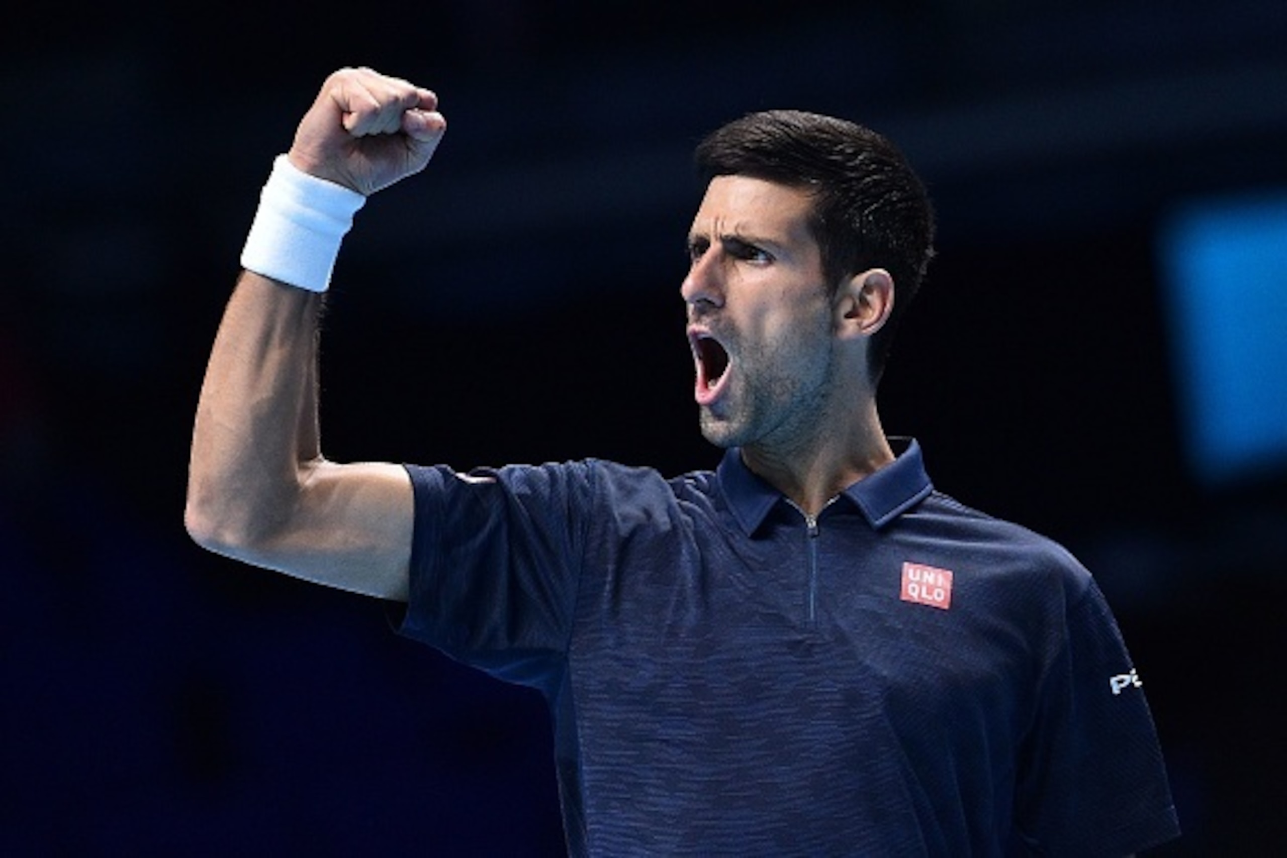 Serbia's Novak Djokovic reacts after taking a 6-5 lead in a first set tie-break against Canada's Milos Raonic during their round robin stage men's singles match on day three of the ATP World Tour Finals tennis tournament in London on November 15, 2016 / A