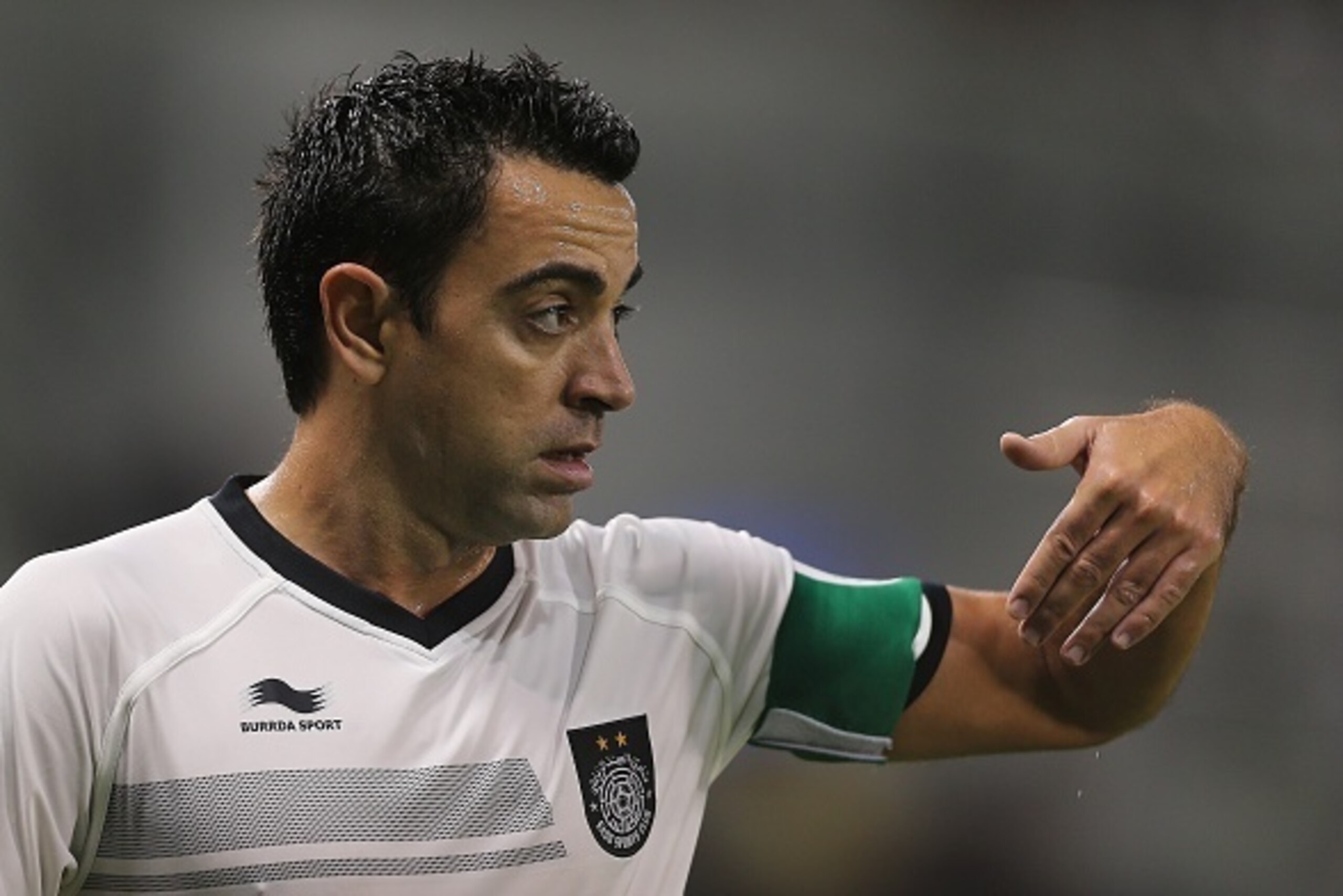 Spain and Barcelona football legend Xavi Hernandez who recently signed with Qatar's Al-Sadd gestures to his teammates during their Qatar Stars League football match against Lekhwiya in Doha on November 27, 2015. AFP PHOTO / AL-WATAN DOHA / KARIM JAAFAR ==