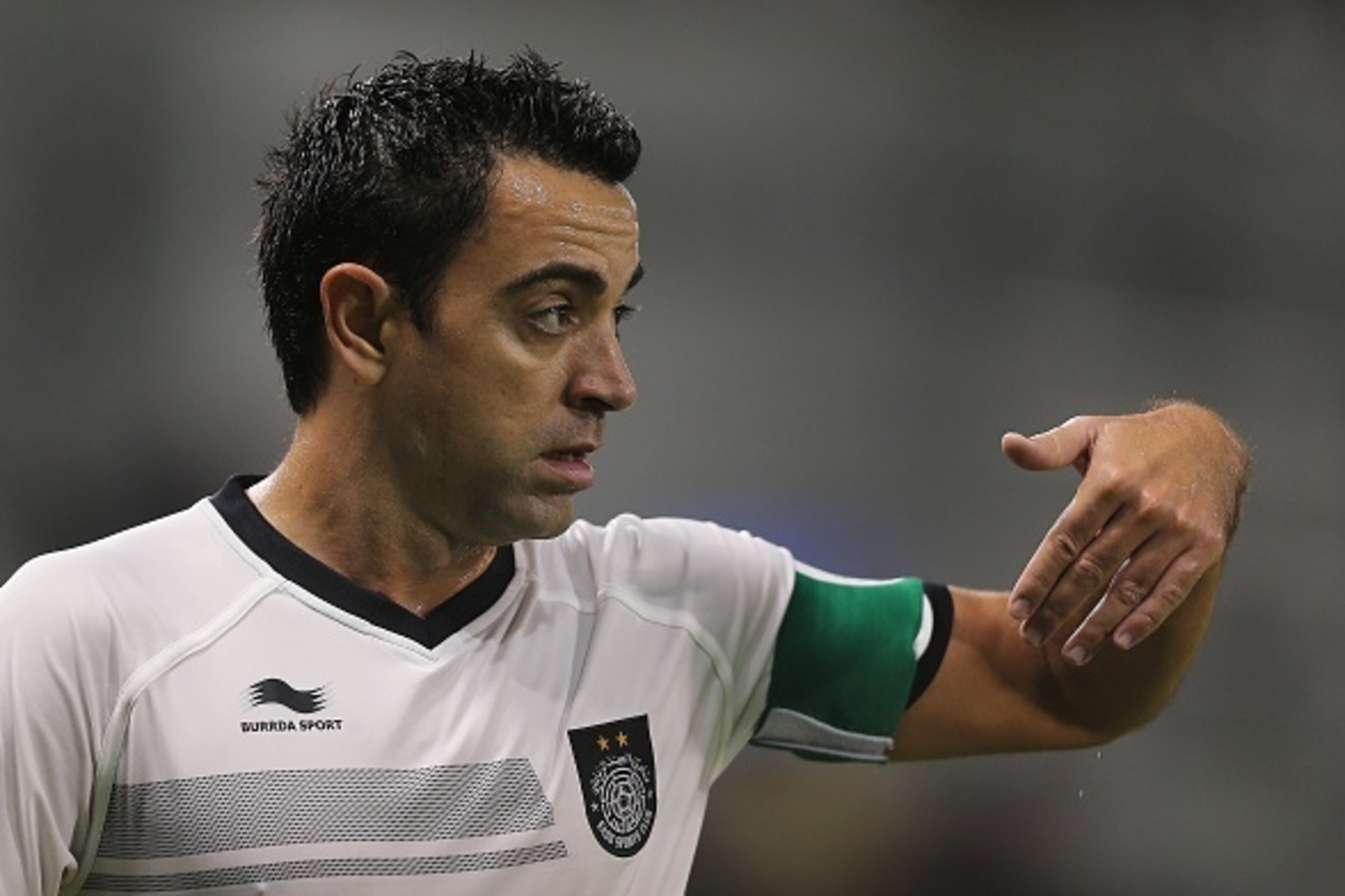 Spain and Barcelona football legend Xavi Hernandez who recently signed with Qatar's Al-Sadd gestures to his teammates during their Qatar Stars League football match against Lekhwiya in Doha on November 27, 2015. AFP PHOTO / AL-WATAN DOHA / KARIM JAAFAR ==