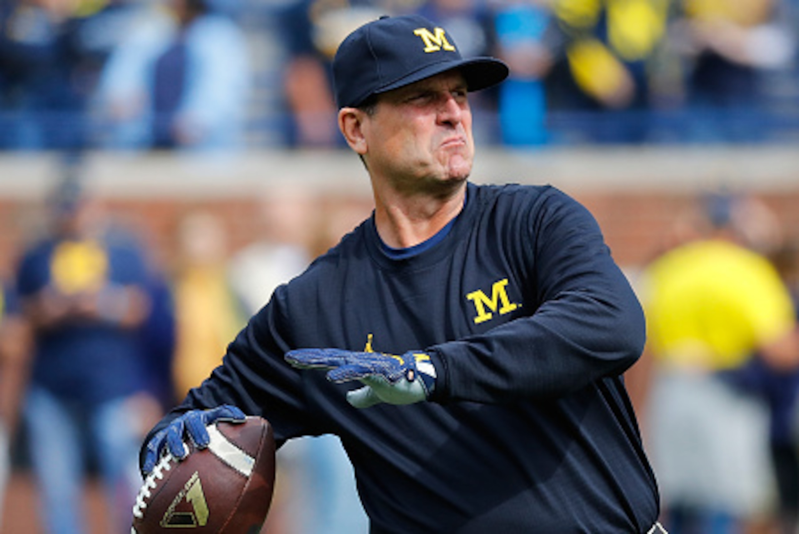 ANN ARBOR, MI - OCTOBER 01: Michigan Wolverines head football coach Jim Harbaugh throws the ball during the pregame warms ups prior to the start of the game against the Wisconsin Badgers at Michigan Stadium on October 1, 2016 in Ann Arbor, Michigan. (Phot ANN ARBOR, MI - OCTOBER 01: Michigan Wolverines head football coach Jim Harbaugh throws the ball during the pregame warms ups prior to the start of the game against the Wisconsin Badgers at Michigan Stadium on October 1, 2016 in Ann Arbor, Michigan. (Phot
