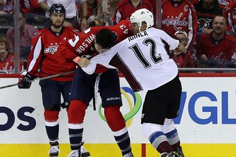 WASHINGTON, DC - OCTOBER 18: Tom Wilson #43 of the Washington Capitals and Jarome Iginla #12 of the Colorado Avalanche fight in the second period at Verizon Center on October 18, 2016 in Washington, DC.  (Photo by Rob Carr/Getty Images)